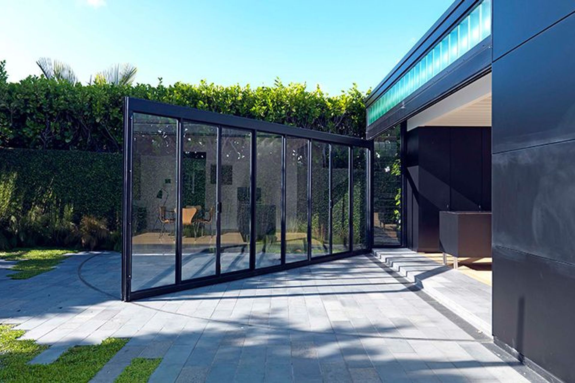 The opening wall of steel joinery and glass incorporates two pairs of French doors that can be used independently when the wall is closed.