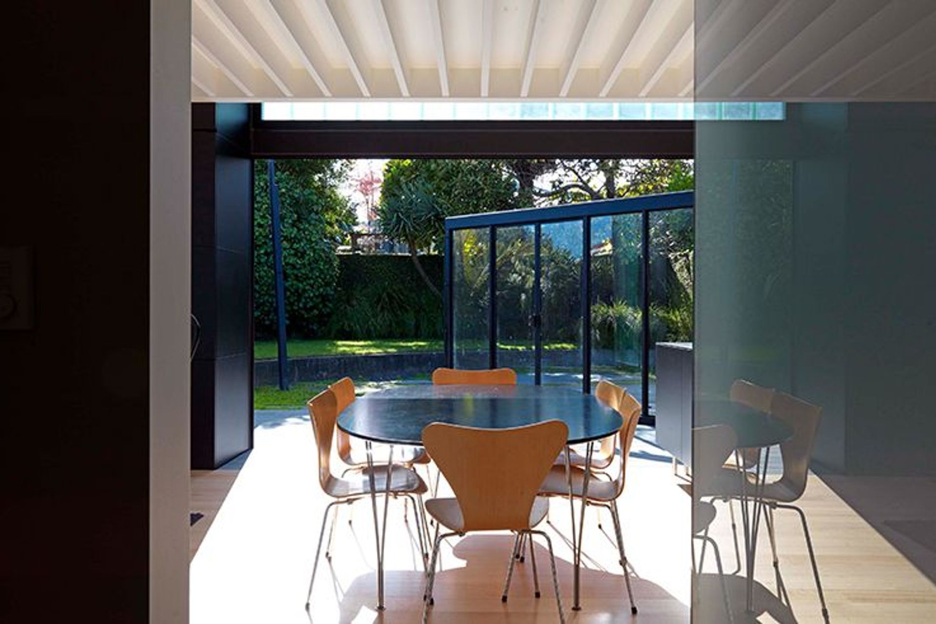 The landscaping of the courtyard features basalt paving that's sits level with the timber flooring inside. 