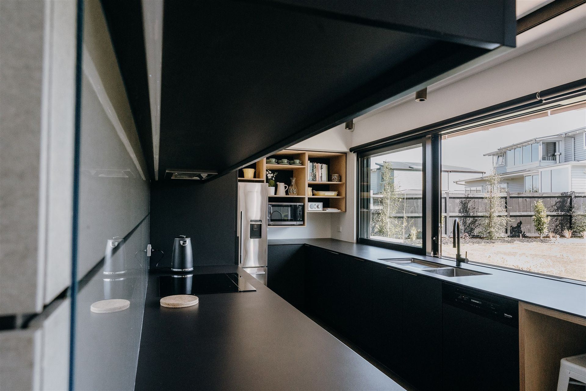 Matte black and timber are the central features in the kitchen, creating a consistent aesthetic in line with the other areas of the home. 