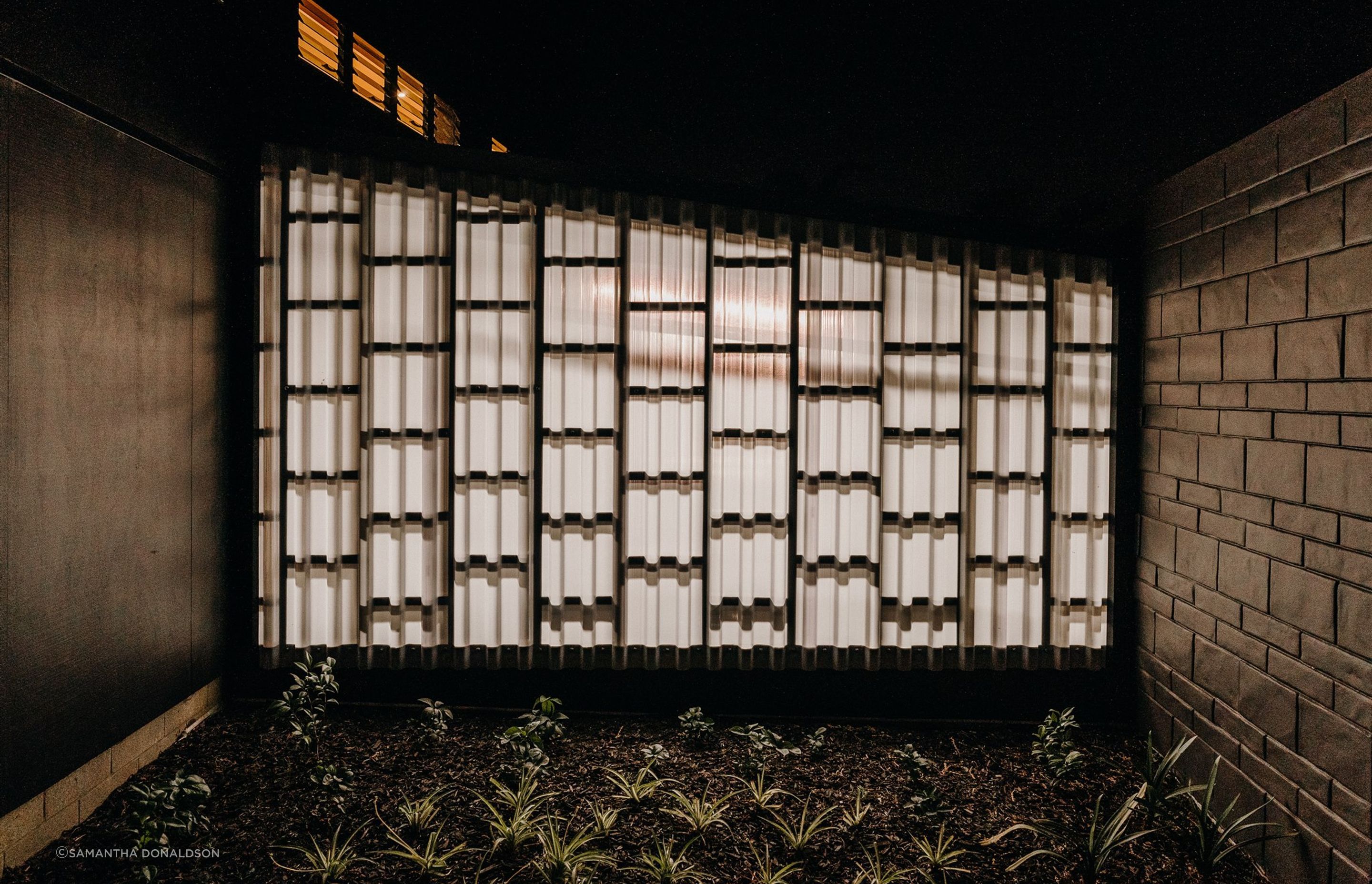 A translucent panel allows for the entrance area to be illuminated at night by the internal garage lighting. 