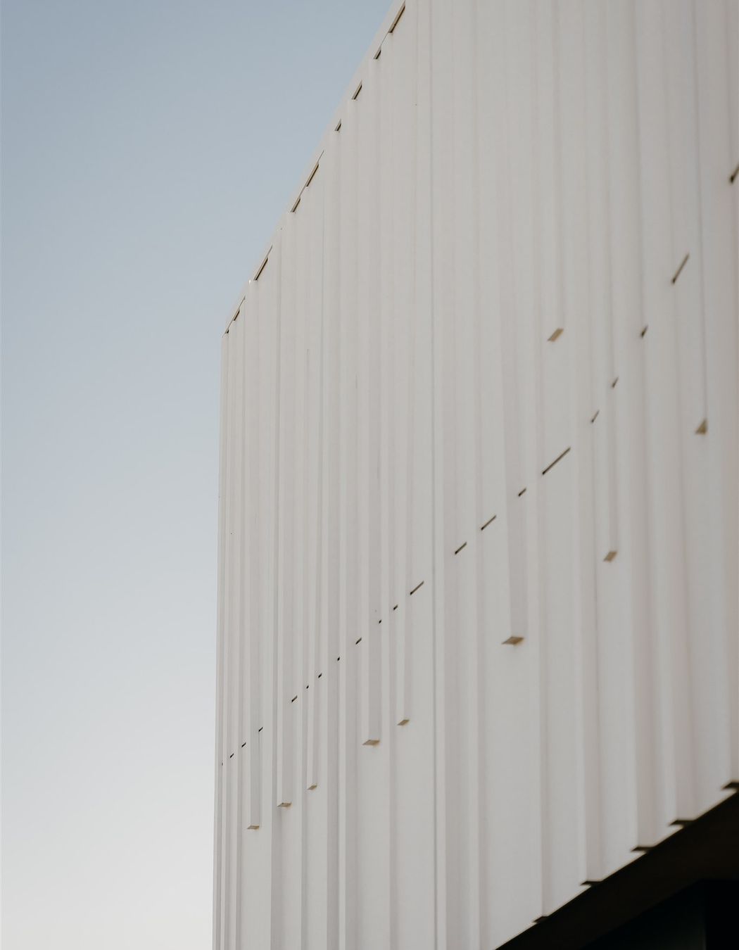 Fluted batons at different angles appear almost as if a piece of fabric had been dropped over the form from a height and created these flutes, almost like curtains