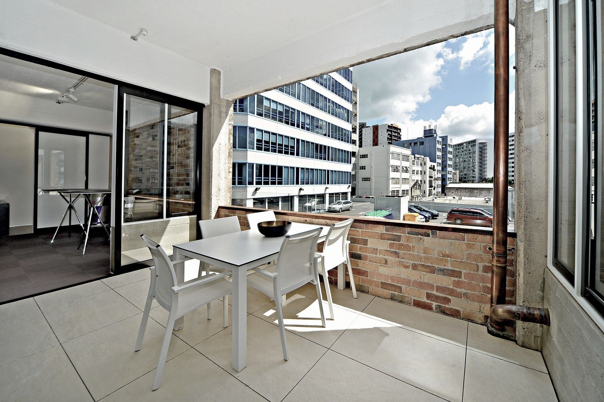 Storm water pipes were recessed within the walls, coming out as a copper pipe feature when they are eventually revealed. Exposed copper pipes have been used in lieu of plastic conduit to conceal data and power cables.