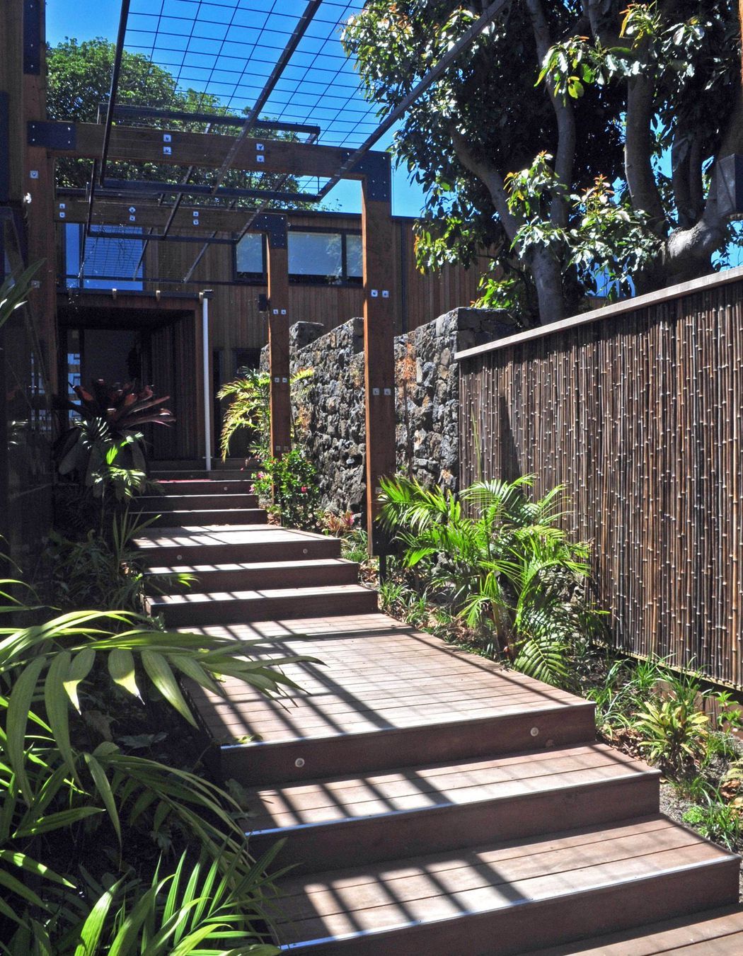 The linear approach to the house is emphasised by the rhythm of steps and arches