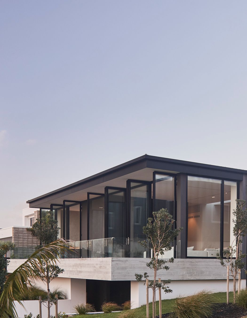 The east-facing balcony is accessed from both the lounge and main bedroom through a bank of full-height, glazed doors.