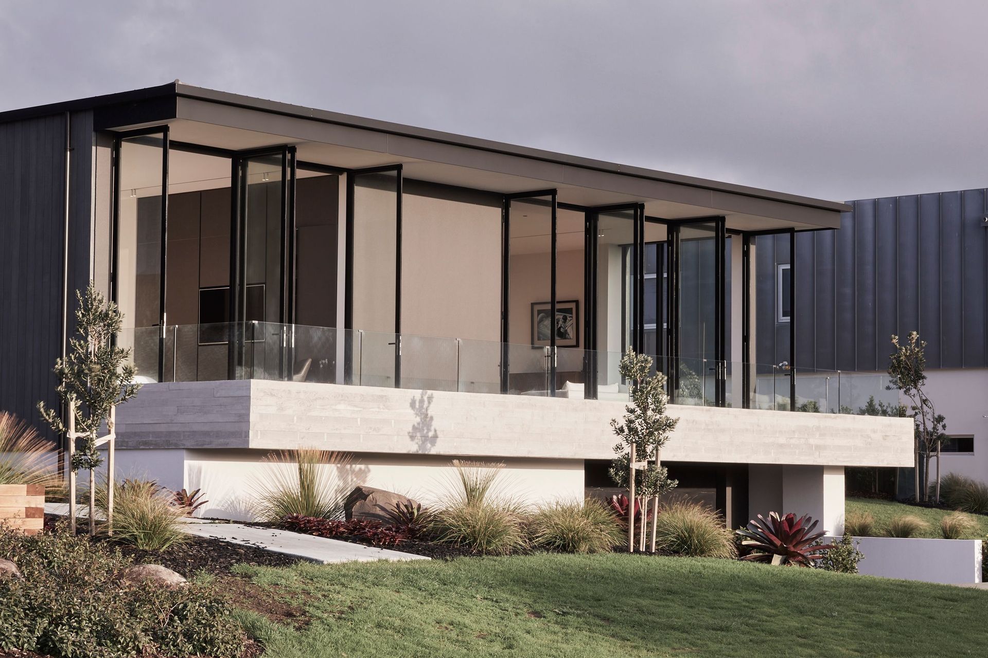 The lounge and main bedroom are positioned three steps down from the main floorplate, creating a 3.5-metre high stud.