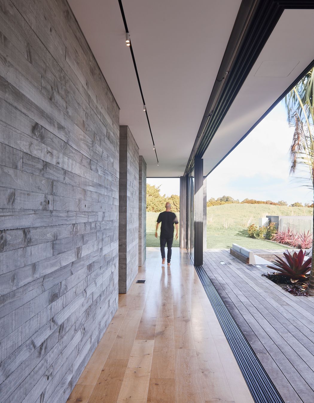 Full-width sliding doors help blur the lines between indoors and out, further enhanced by the textural nature of the chosen materials.