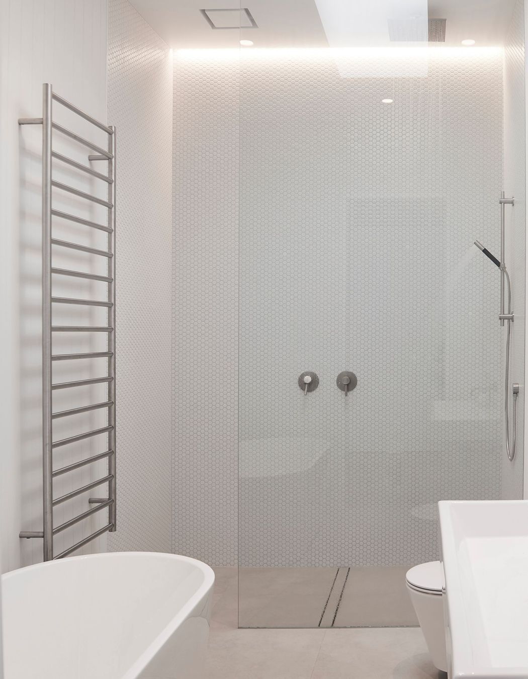 A monochromatic scheme was chosen for the bathrooms to impart a sense of pure simplicity.