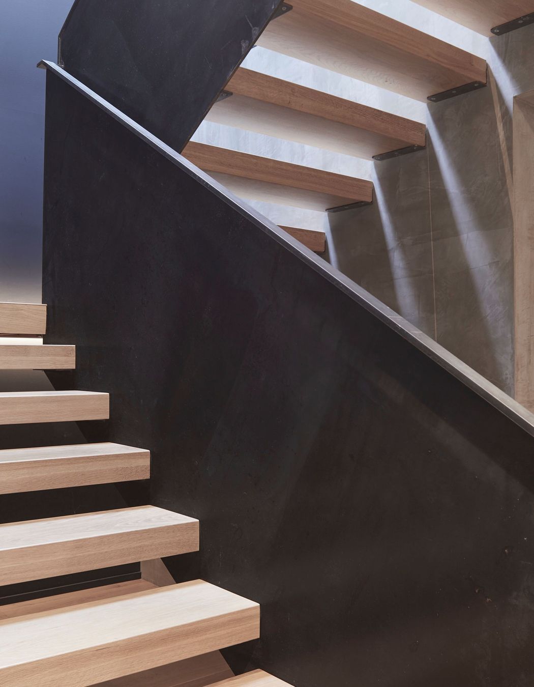 Timber treads help to visually soften the metal balustrades and concrete walls.