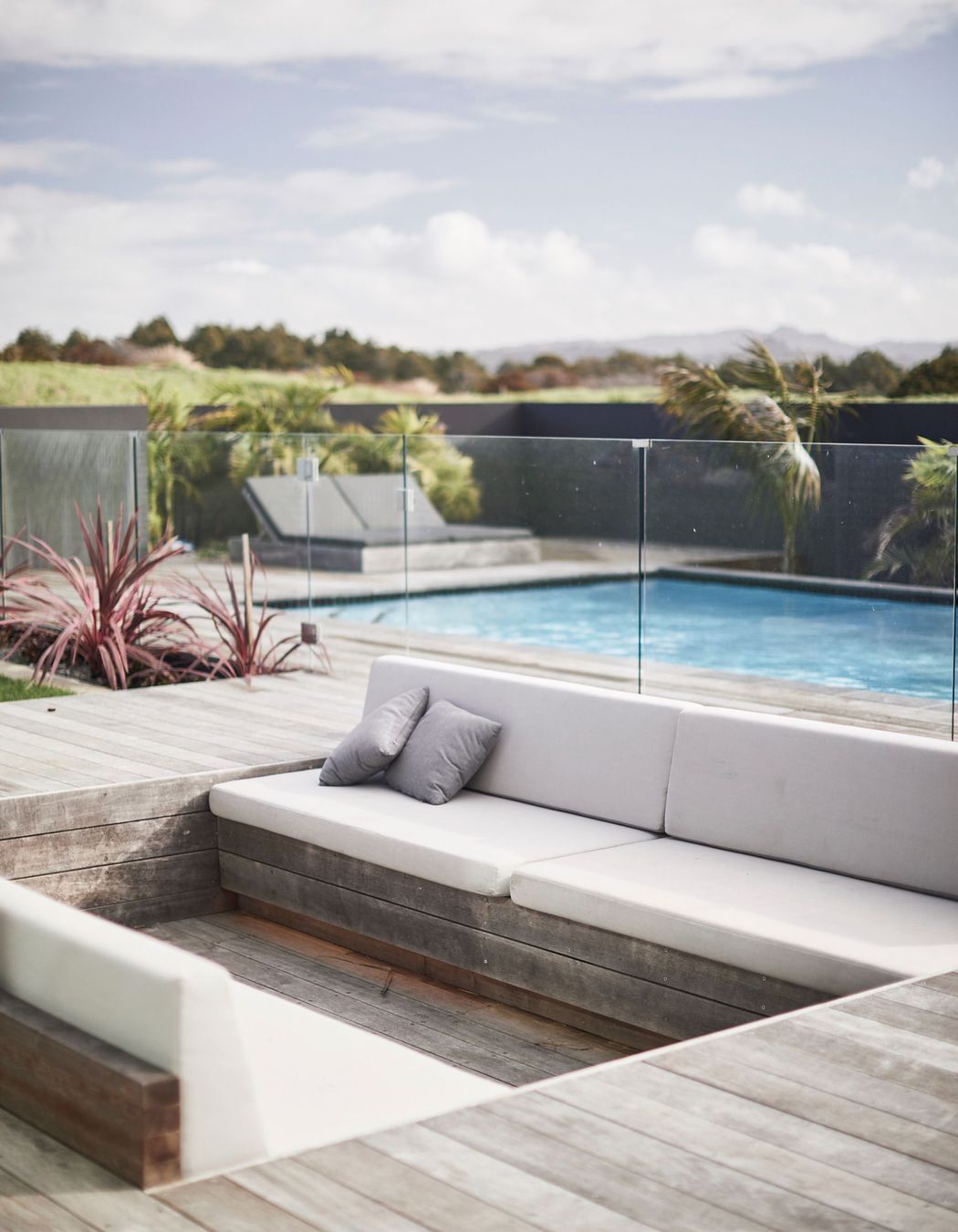 A sunken conversation pit at the far end of the outdoor entertaining area provides an intimate and sheltered spot for people to gather.