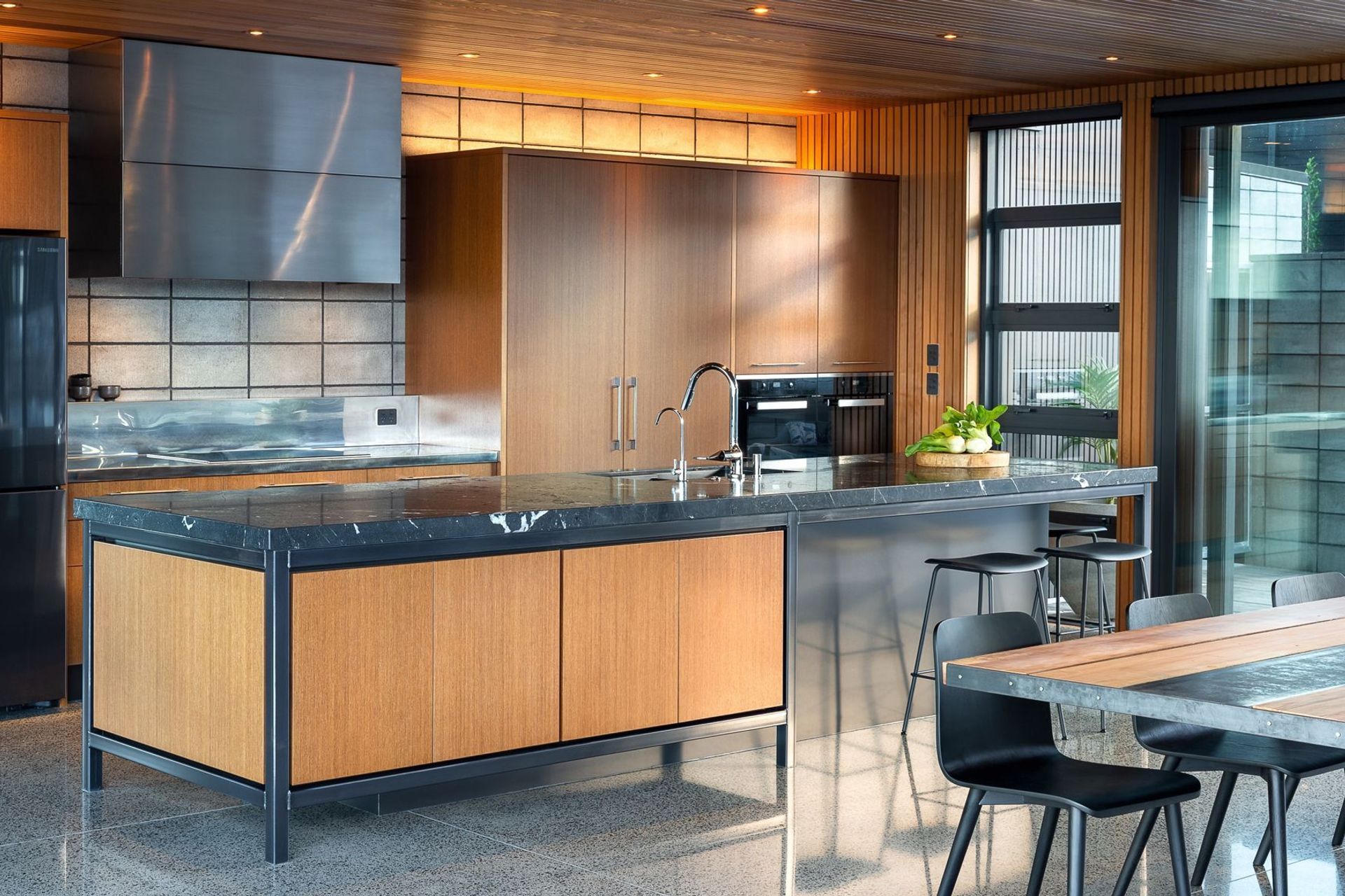 Zones have been created throughout the kitchen to keep the flow and ergonomics at its prime, while the front of the island conveniently houses drinks and homework resources.