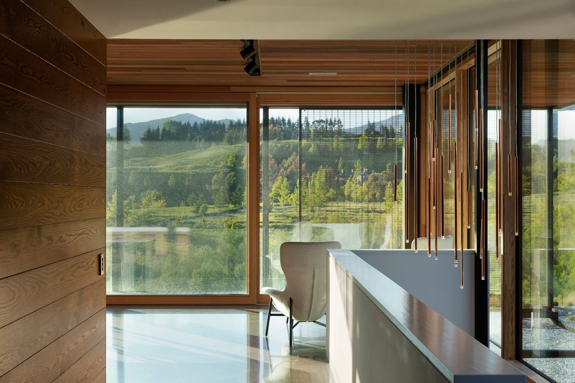 A hallway with a view and a feature light pendant.