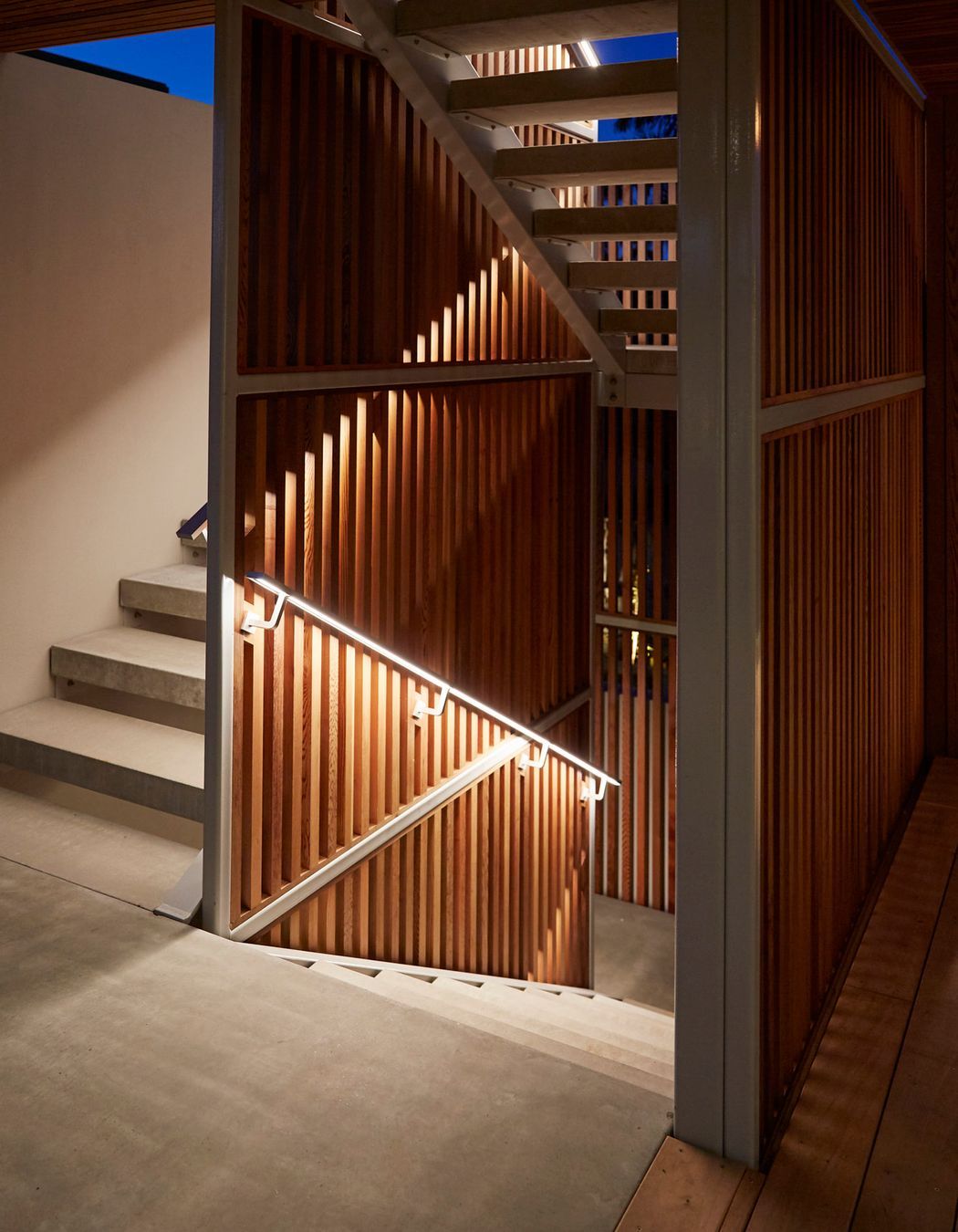 Custom built stairwell handles feature under-lit lighting to guide during darkness. Calley Homes | Tauranga Builders