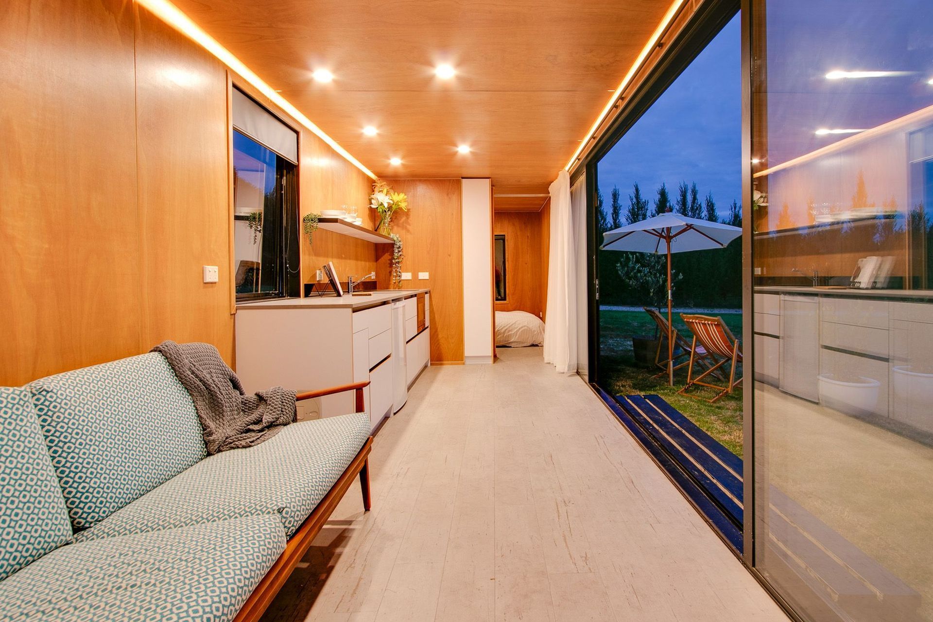 The living and kitchen area leads into the bedroom via a sliding door.