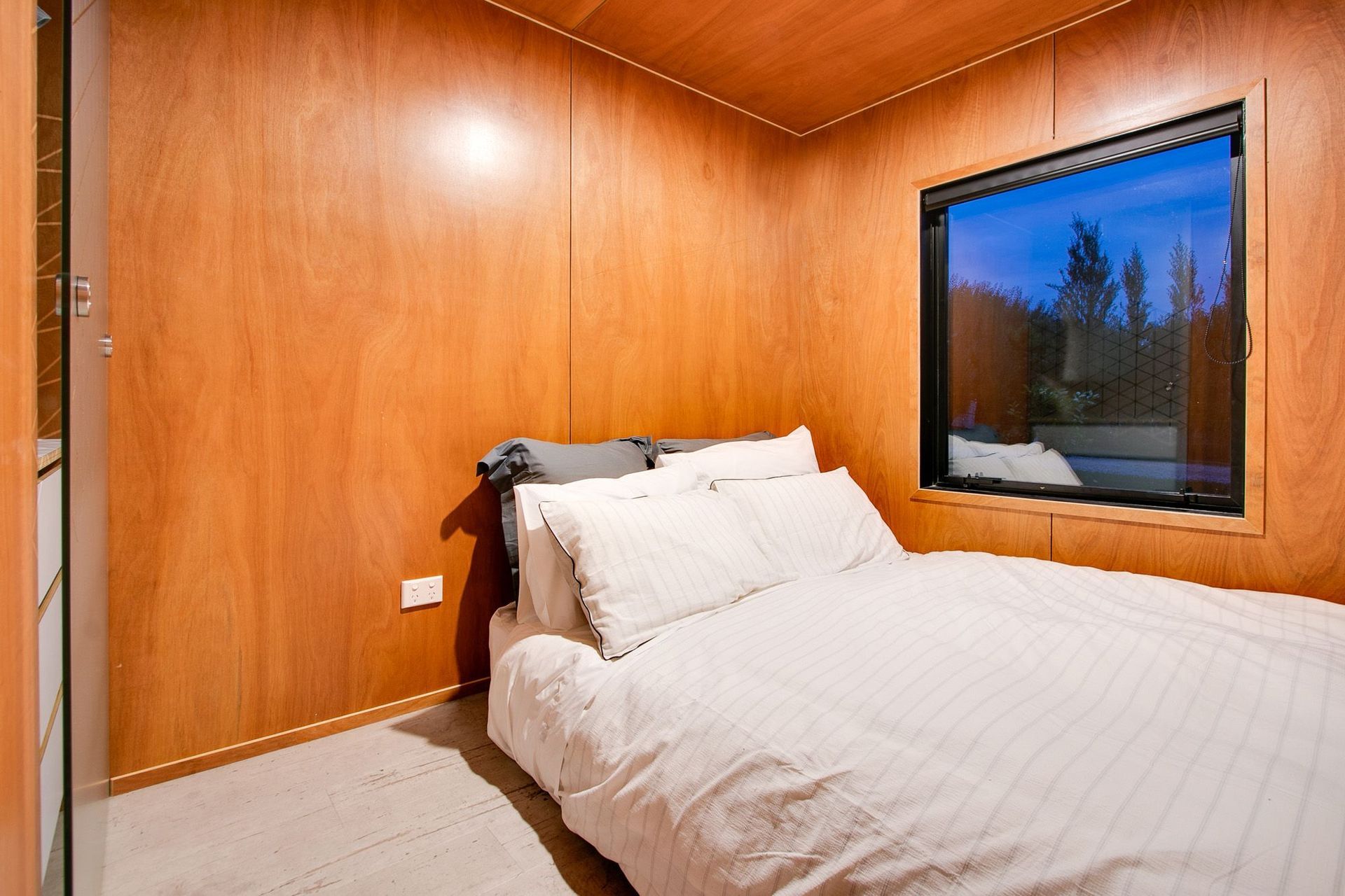 A simple bedroom has built in storage.