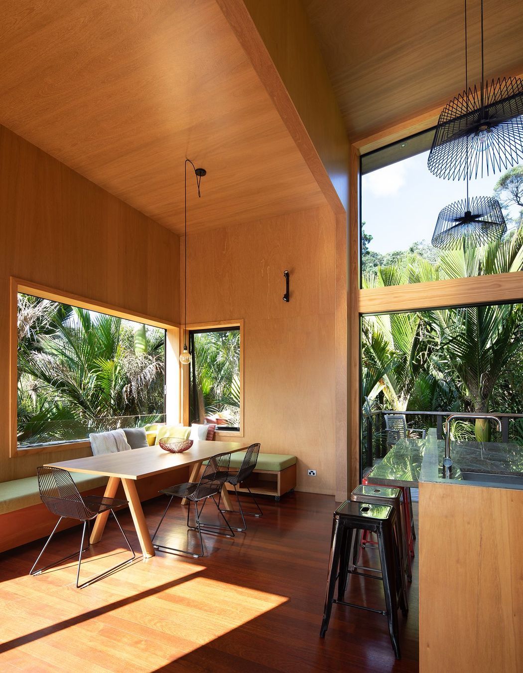 The kitchen/dining area maximises space with built-in bench seating and high ceilings.