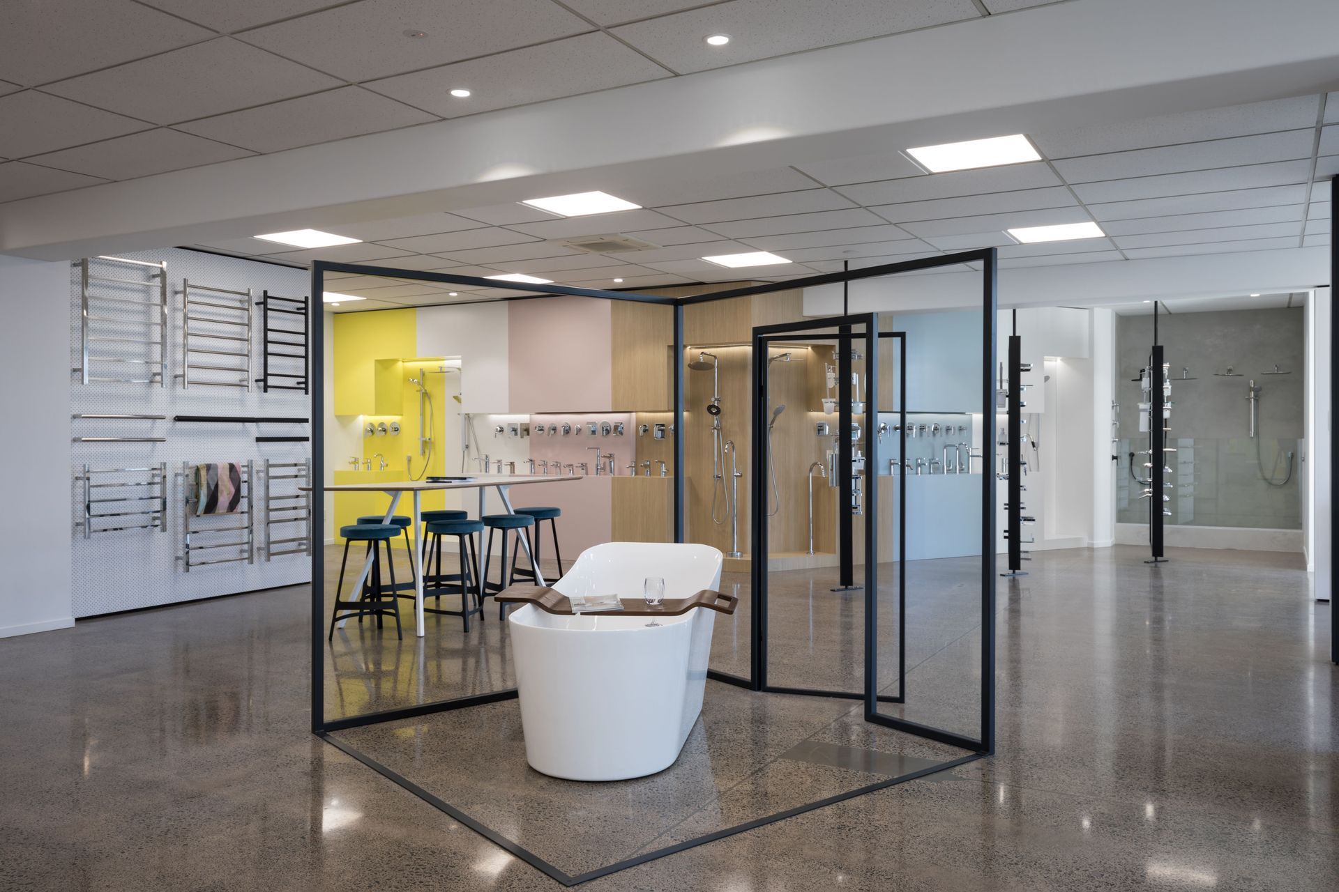 Block colour on the display walls ties back to colour emersion pods on the other side of the showroom. Revolving screens display still more hardware, fixed ceiling and floor (seen side on here)