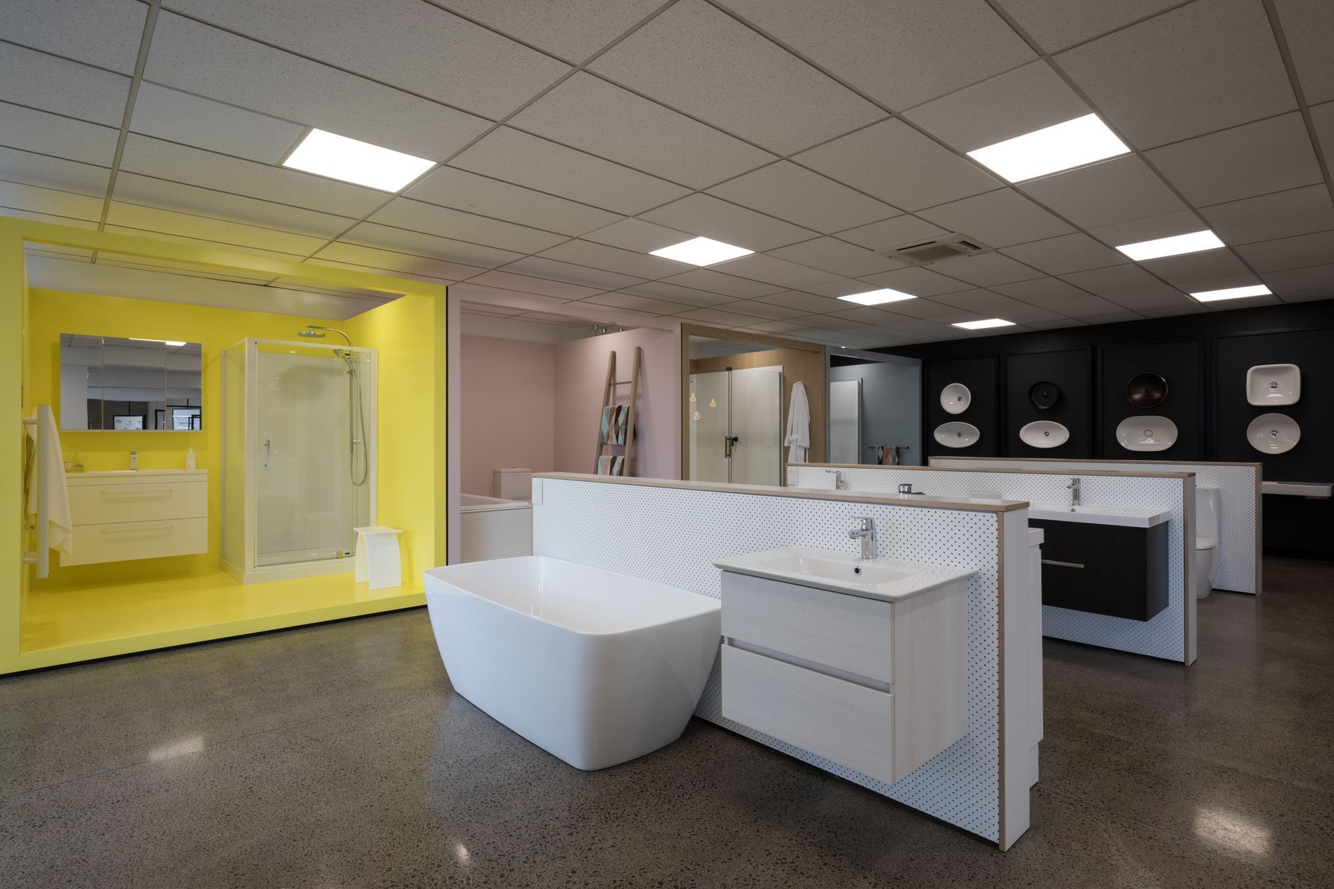 Peg board half walls allow flexibility and economy for changing out product as floor displays are updated. The black rear wall adds depth to the space overall, and product shape and form pops as abstract/geometric elements in the space.