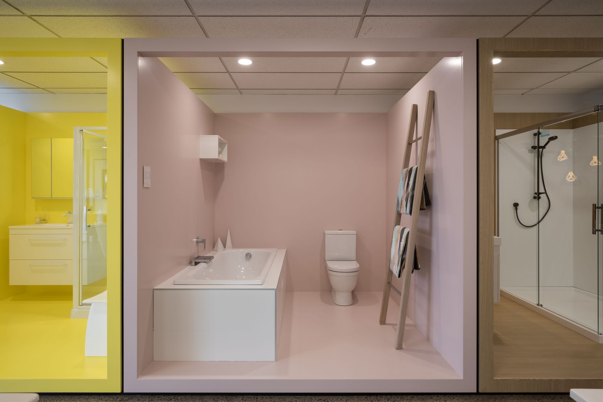 Room pods emerse the client in various moods and make the product hero: yellow, pink, wood and blue create visual interest from the street and draw clients into the showroom