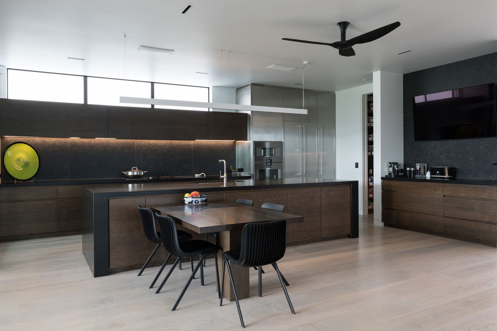 The kitchen has a casual breakfast table, a corner pantry, as well as a coffee and media station to the right.