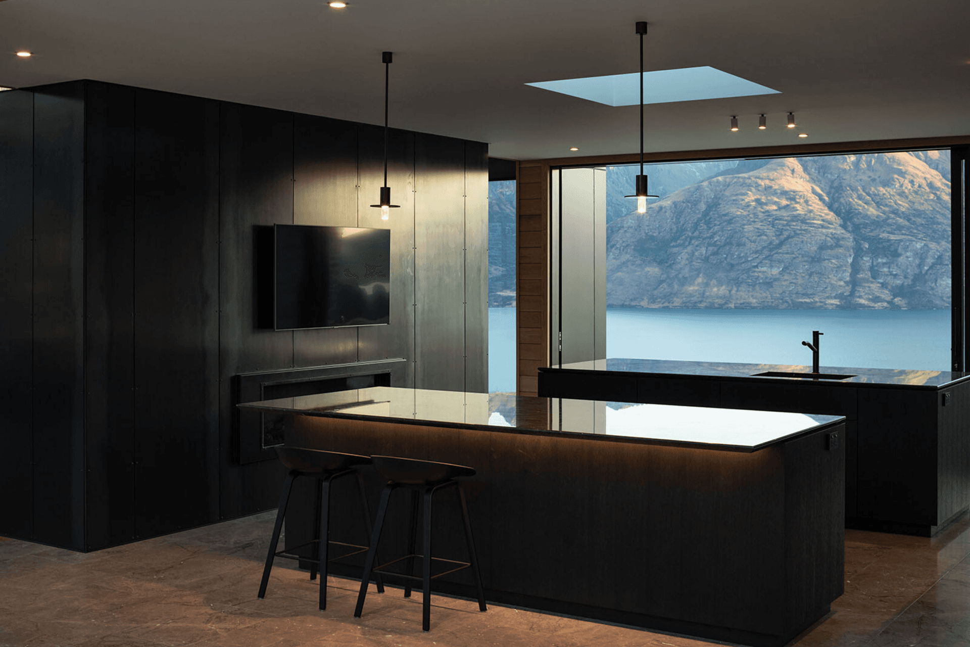 On either side of the kitchen are glass sliders that feature stunning views of the lake on one side, and the mountains on the other.