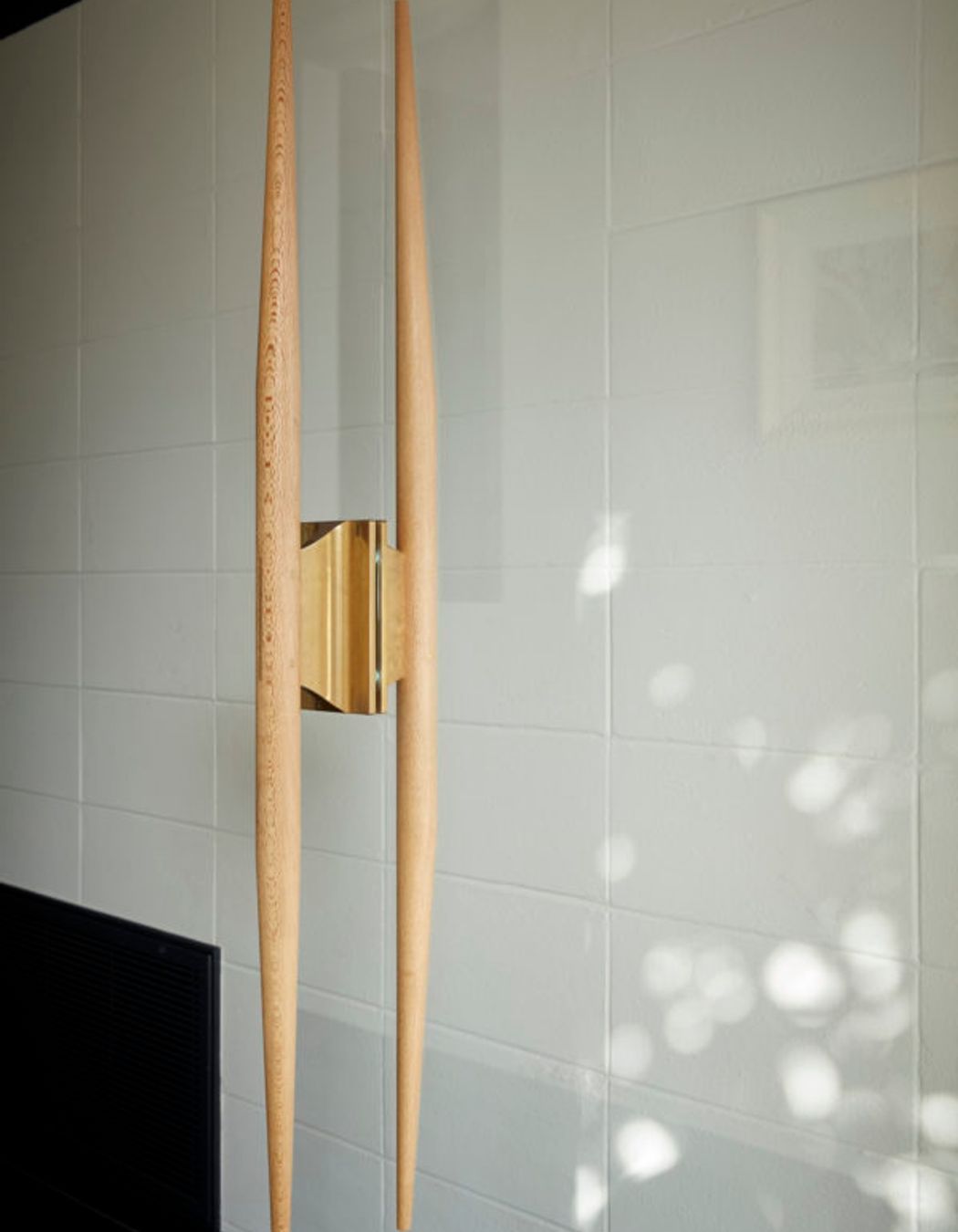 Bespoke timber and brass front door handle, custom designed by DMA.