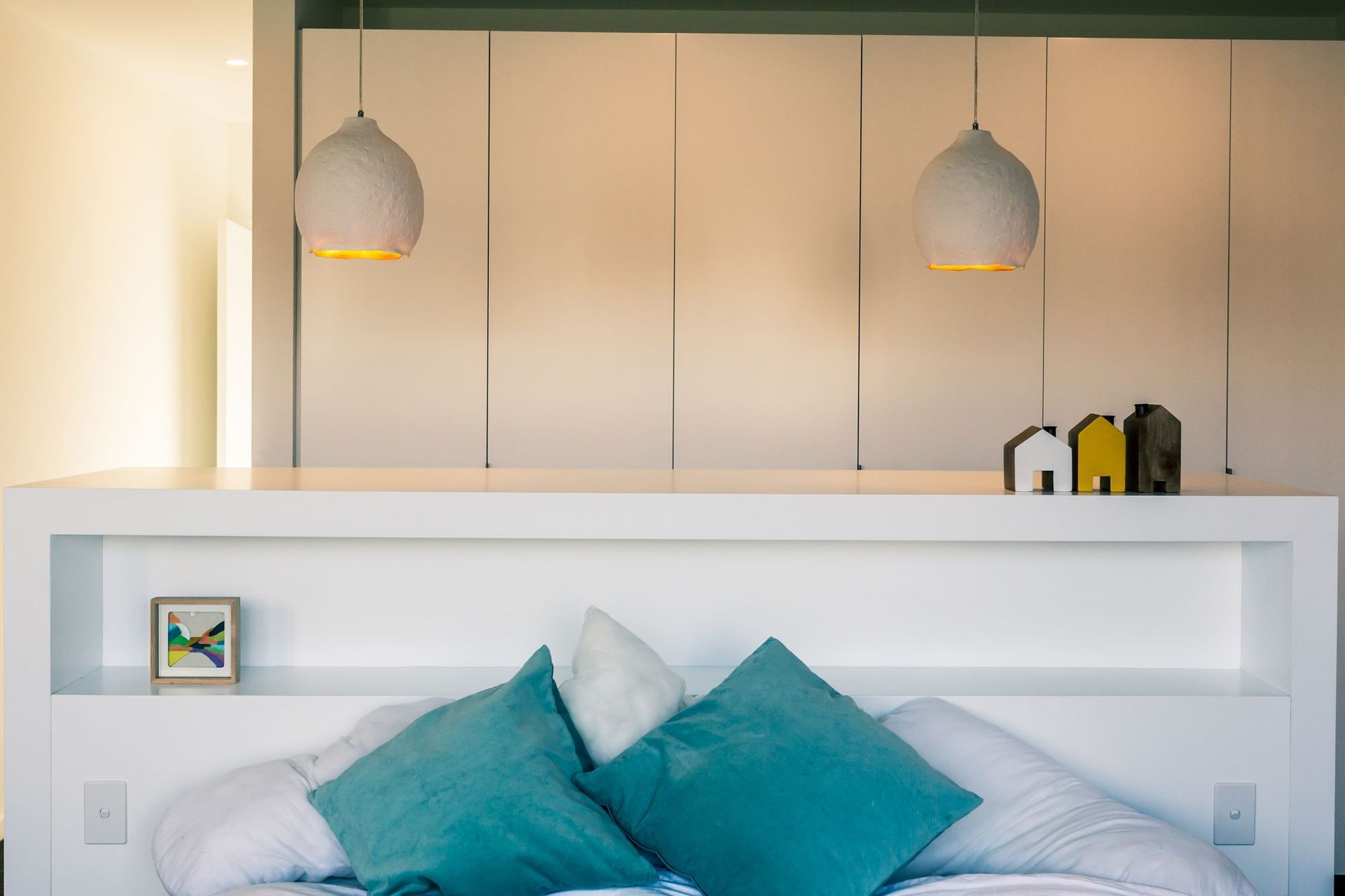 A pared-back colour scheme in the main bedroom keeps the feeling light and fresh.