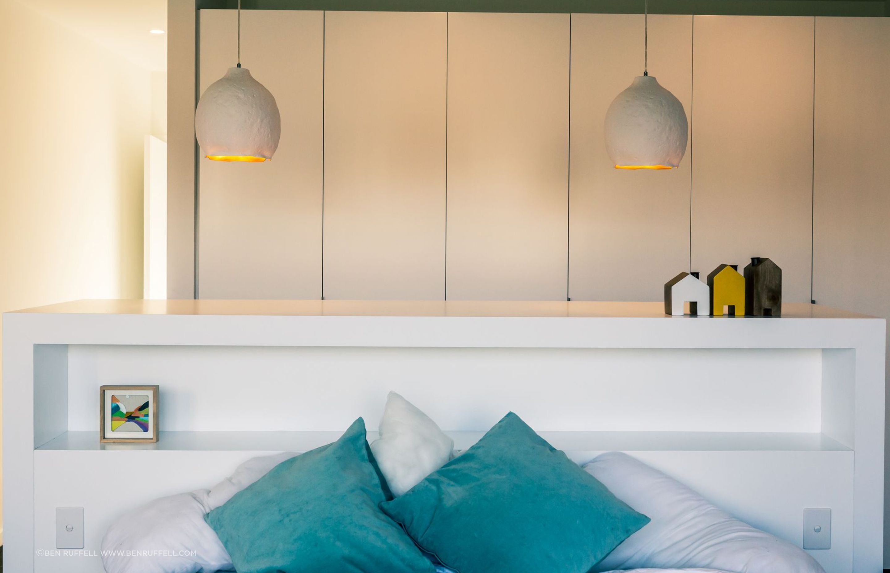 A pared-back colour scheme in the main bedroom keeps the feeling light and fresh.