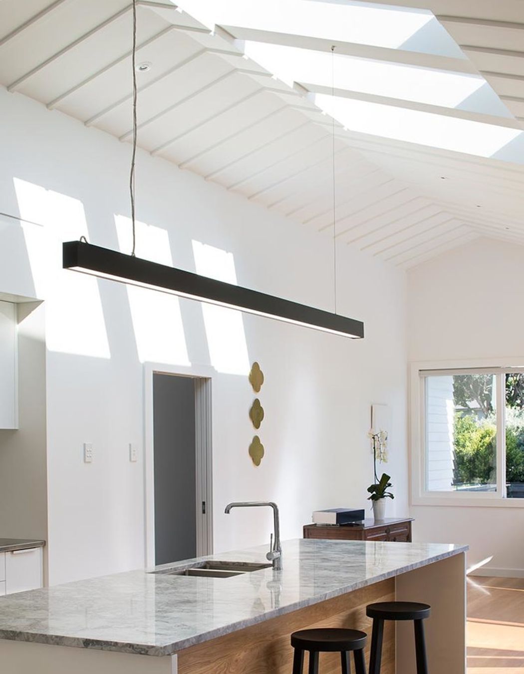 Central to the renovation was providing more light through skylights. The existing traditional profile of the roof / ceiling was preserved, and complimented by clean, bold skylights that enhanced the sense of space in the house.