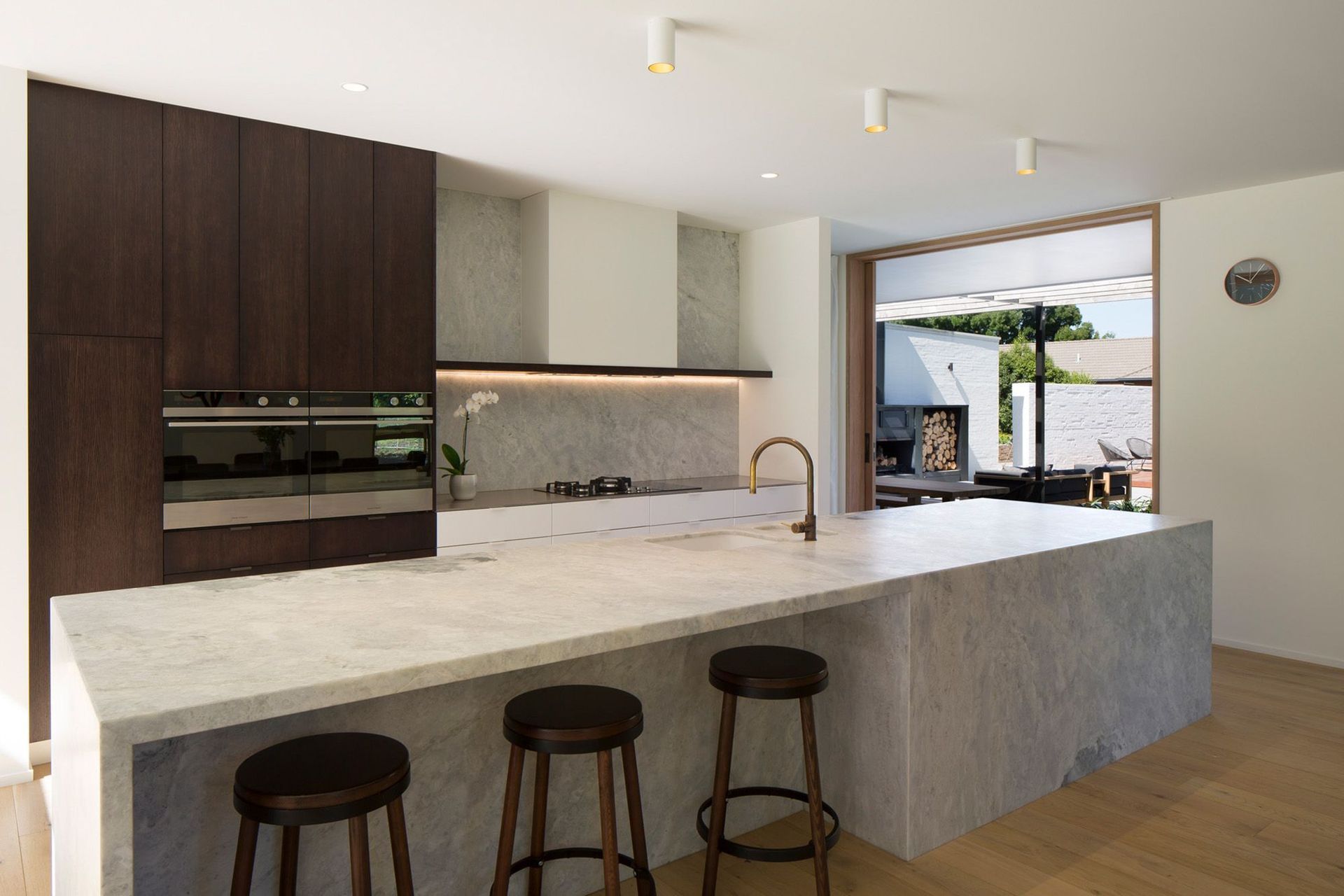 The kitchen has a modern yet timeless aesthetic through the use of natural materials in a refined neutral palette, with Fisher &amp; Paykel built-in duel ovens.