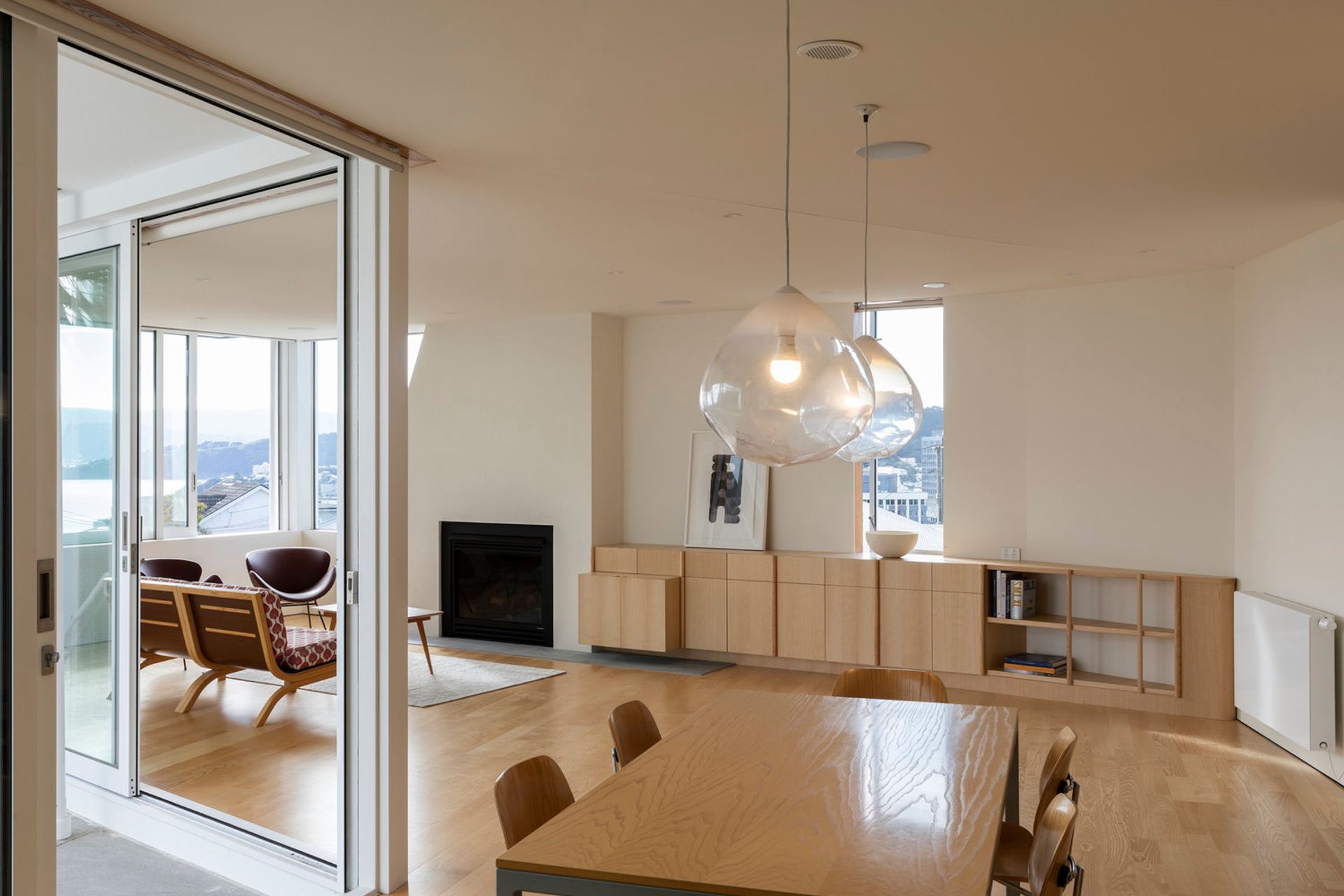The living area of the downstairs apartment leads out to a terrace on the left and features views over Wellington Harbour.