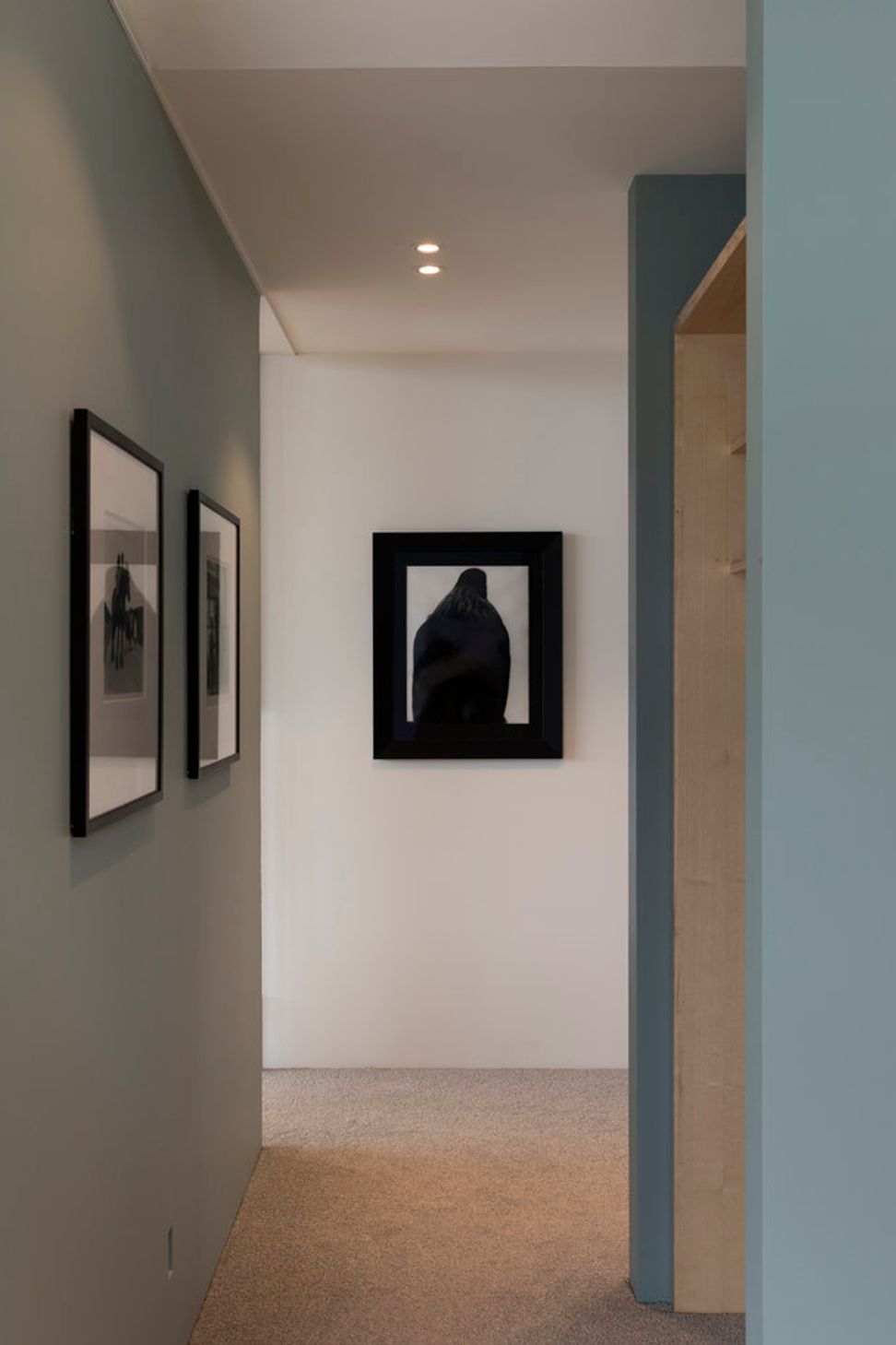 The hallway shows Parsonson's signature colour palette of soft, muted greens and blues.