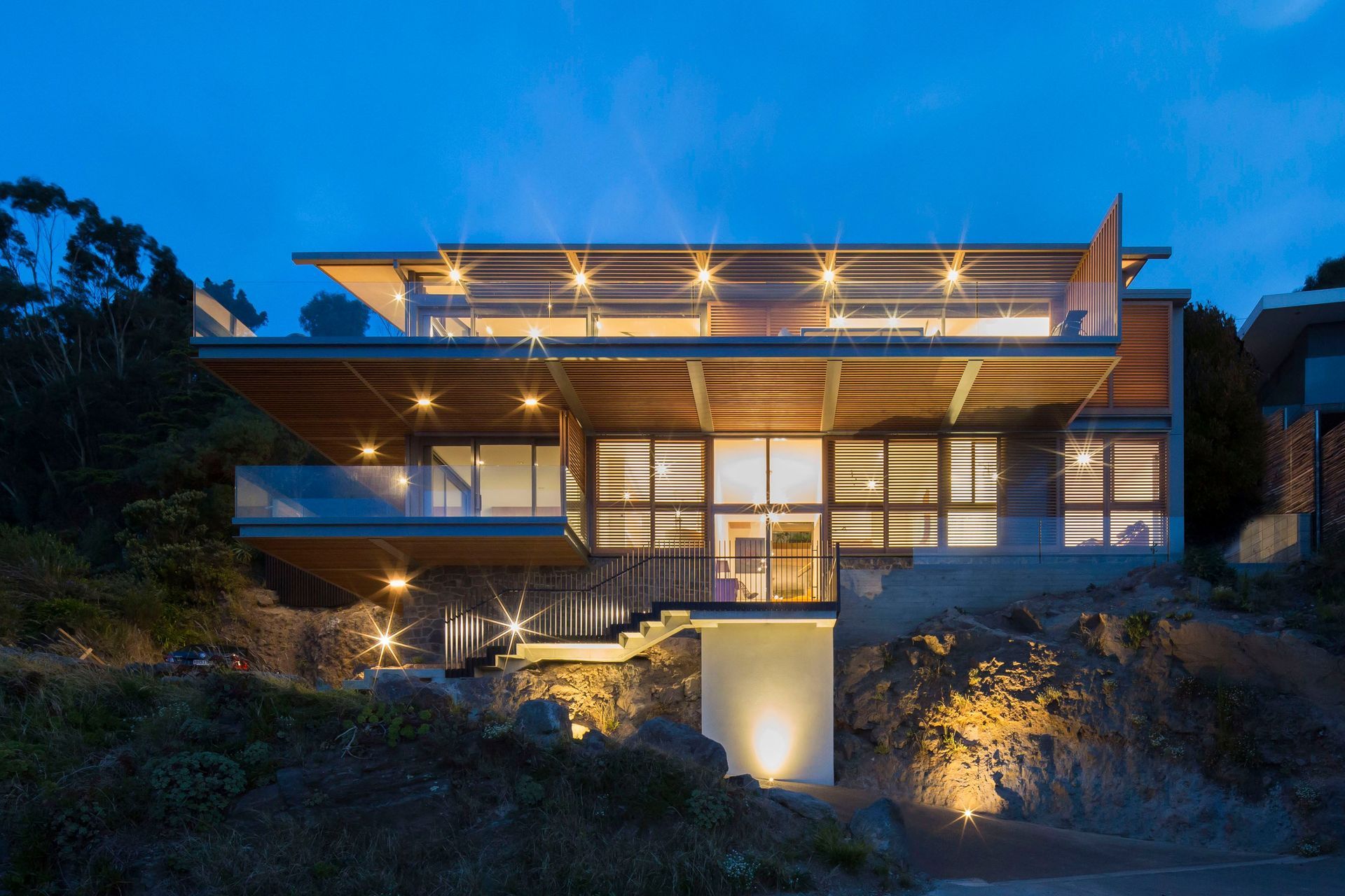 Like a beacon, the house glows at night.