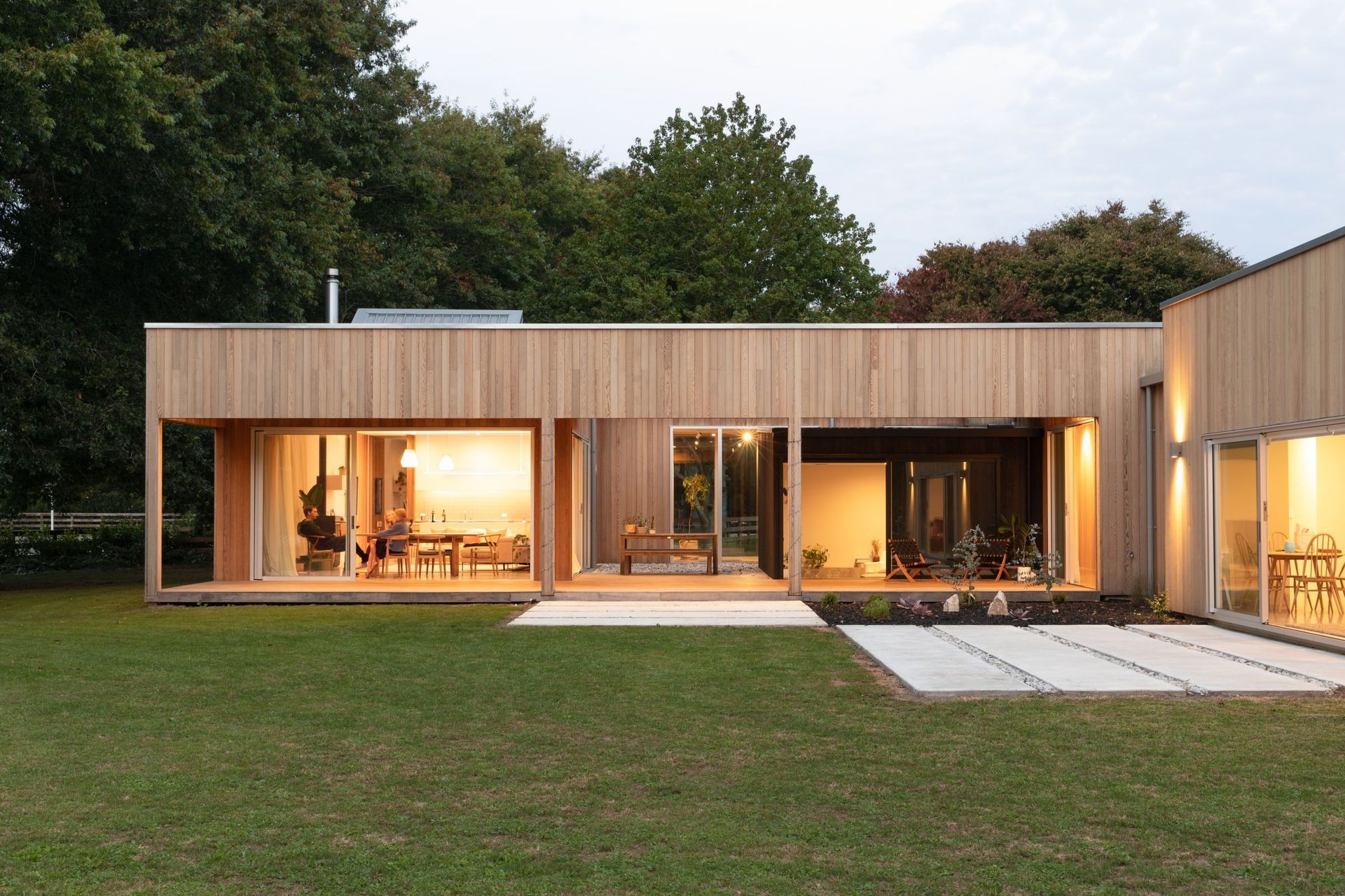 The main pavilion contains the living and dining areas, and an internal courtyard. The spatial arrangement creates a sense of a journey through the home.