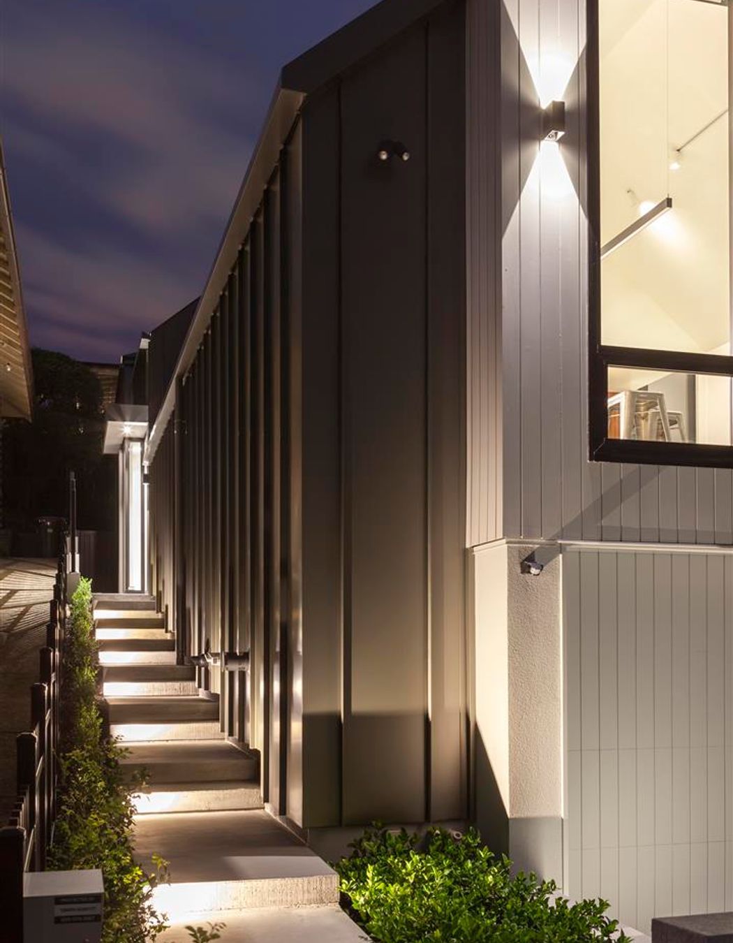 Vertical shiplap weatherboards provide a nod to the heritage nature of the area while long-run steel, which has been wrapped down the sides of the house, give it a very contemporary feel.