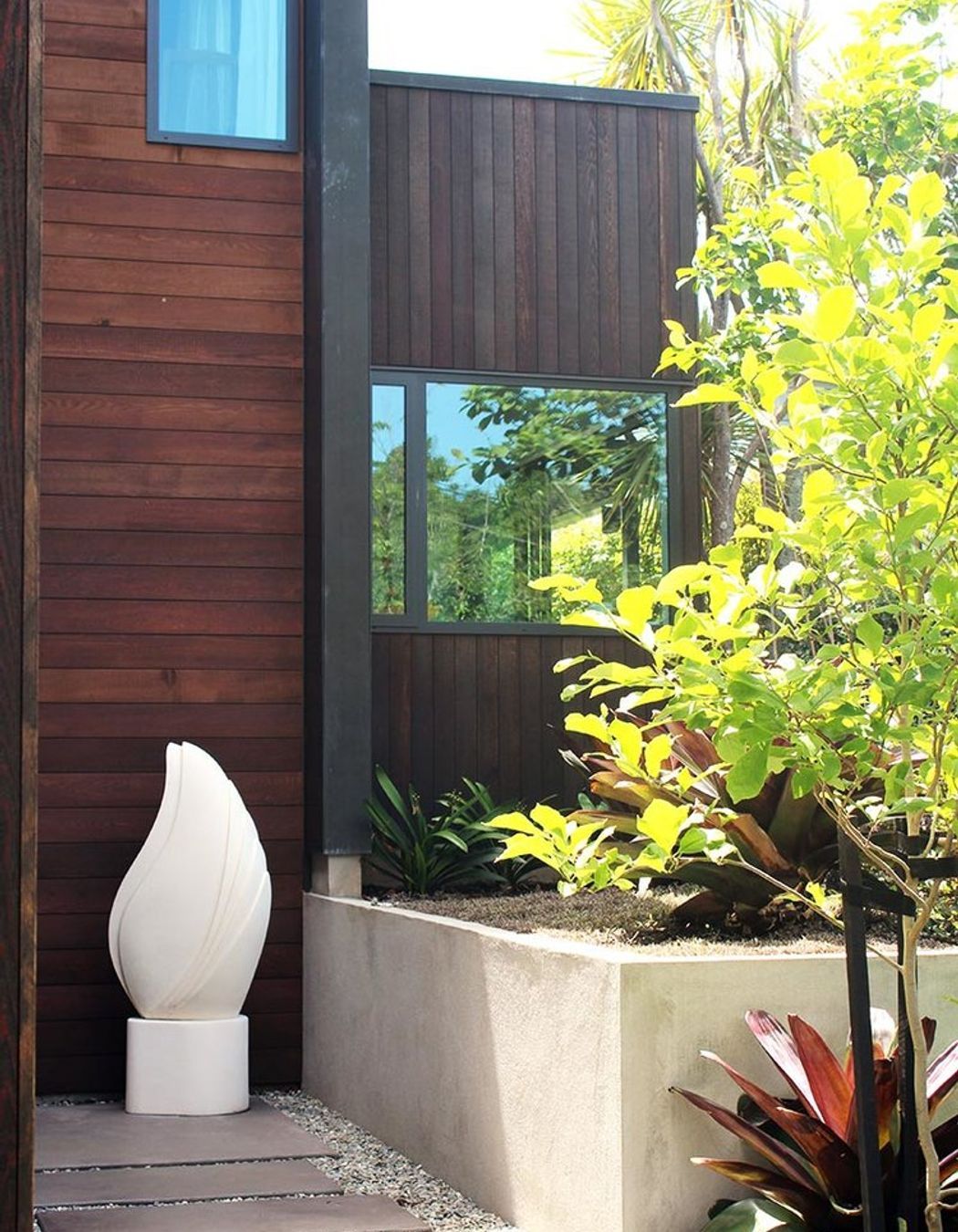 The warm tones of rich cedar weatherboards and cedar slats create a softness next to the dark grey zinc clad walls.