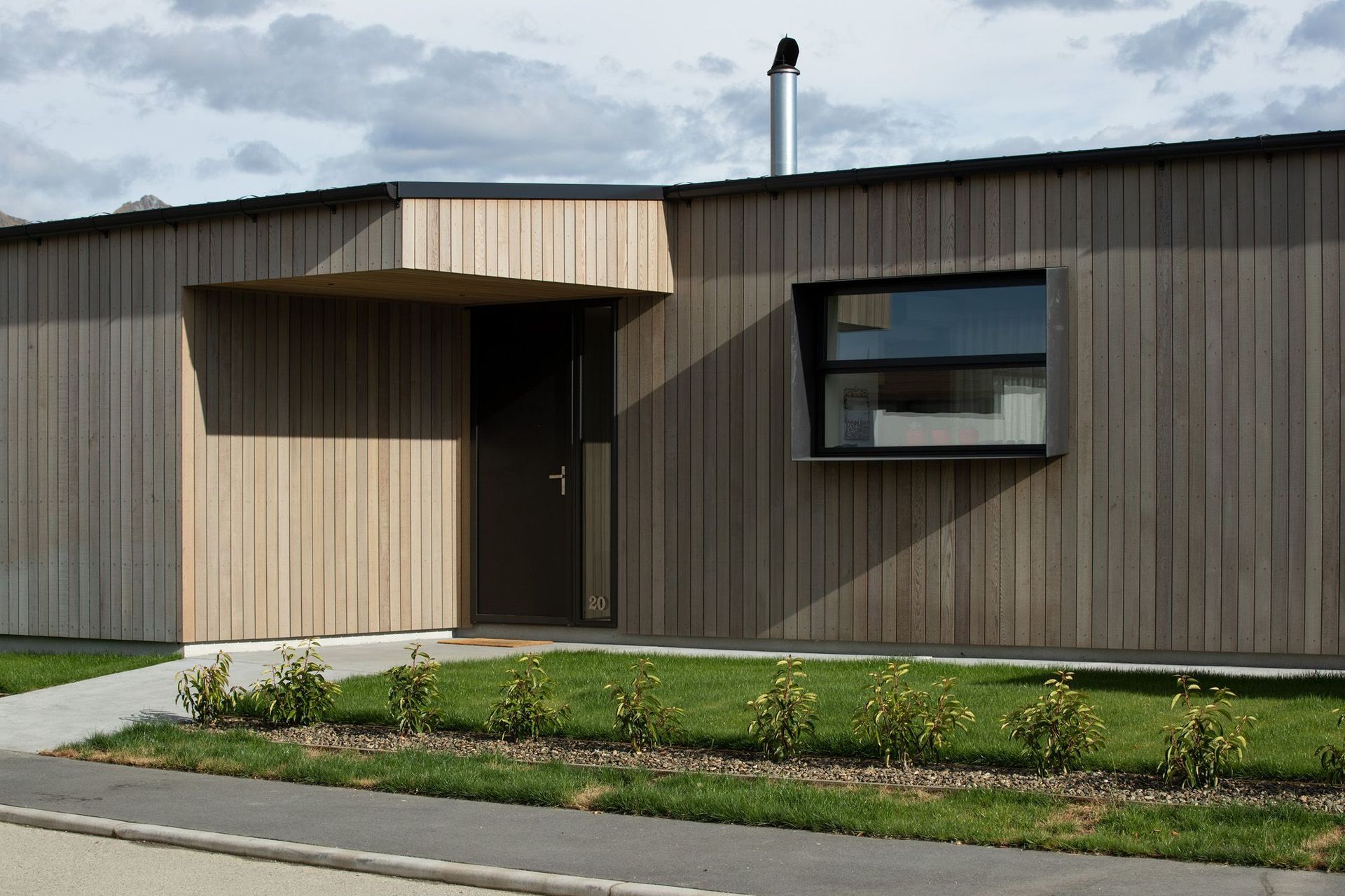 The timber cladding continues over this entrance, giving the home a seamless contemporary form.