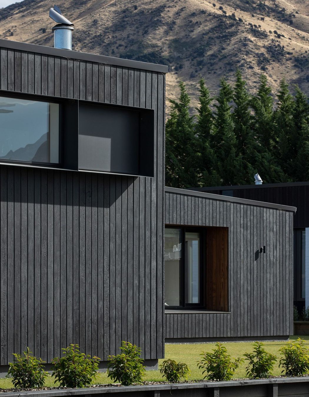 Charred Abodo wood cladding provides a contrast to the cedar-clad homes.