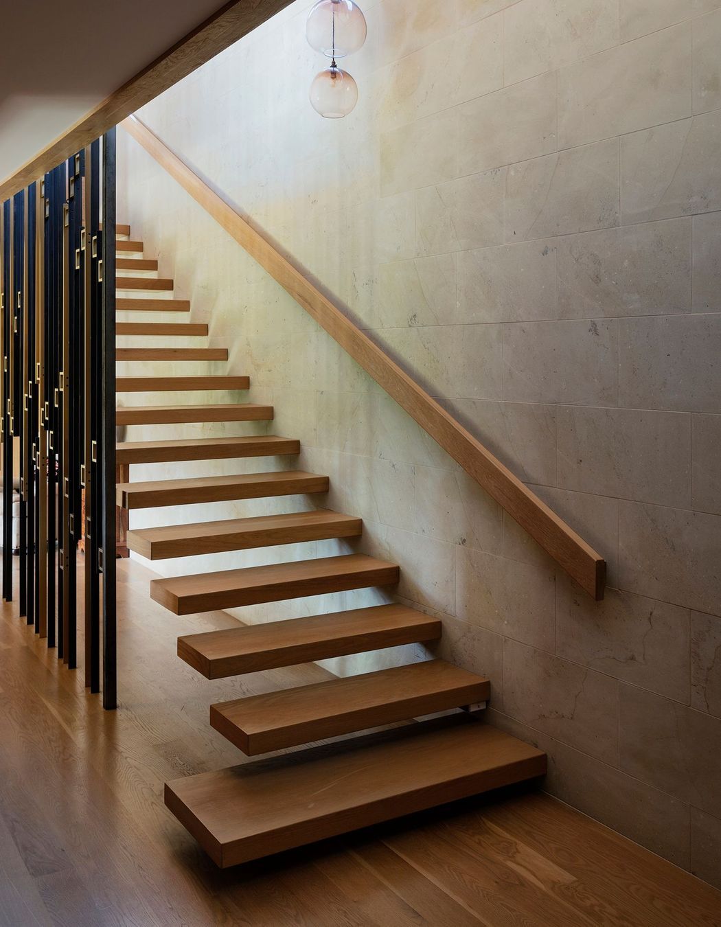 The staircase, with its brass and steel ‘sequin’ screen, sits at the heart of the home.