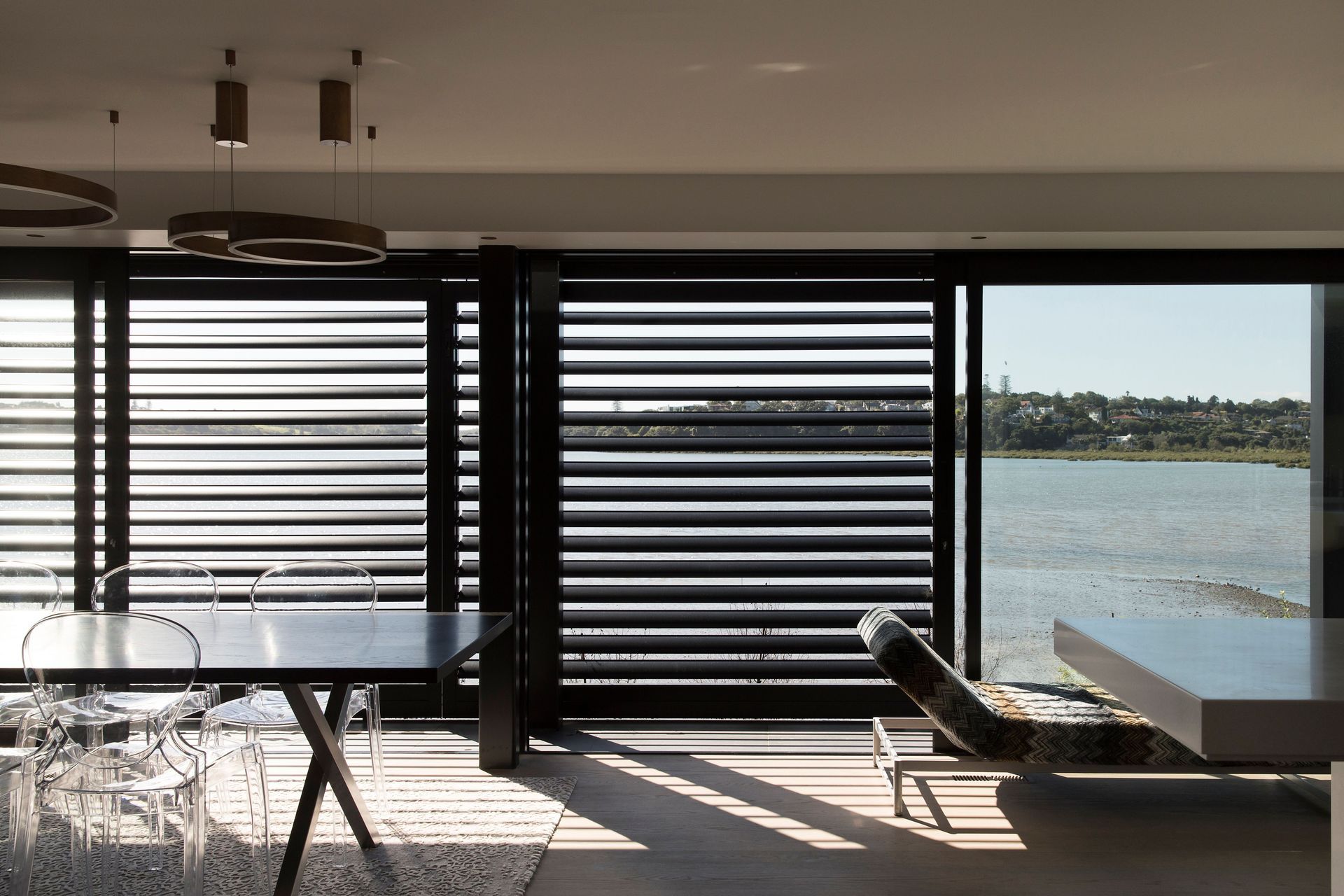 Louves help to shade the interior from the northern sunlight and create a horizontal pinstriped effect on the exterior and in the shadows cast on the floor.