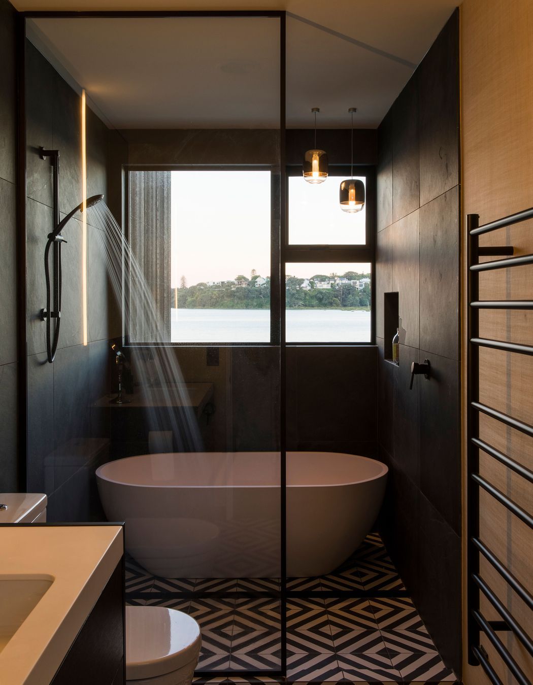 The guest bathroom on the upper-level enjoys a waterfront view.