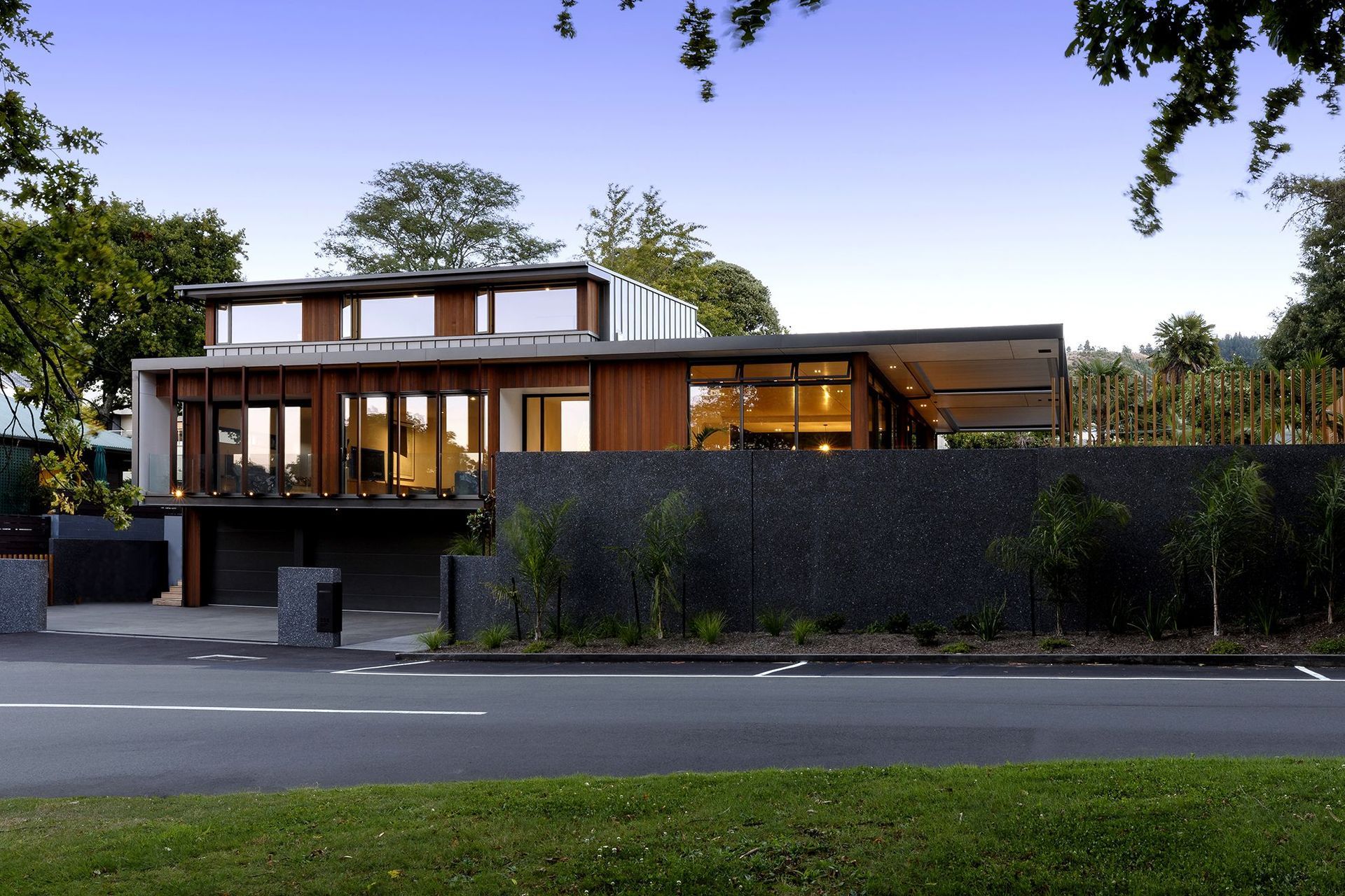 The front elevation at dusk showcases the clever articlulation of forms that help to break down the mass of the building.