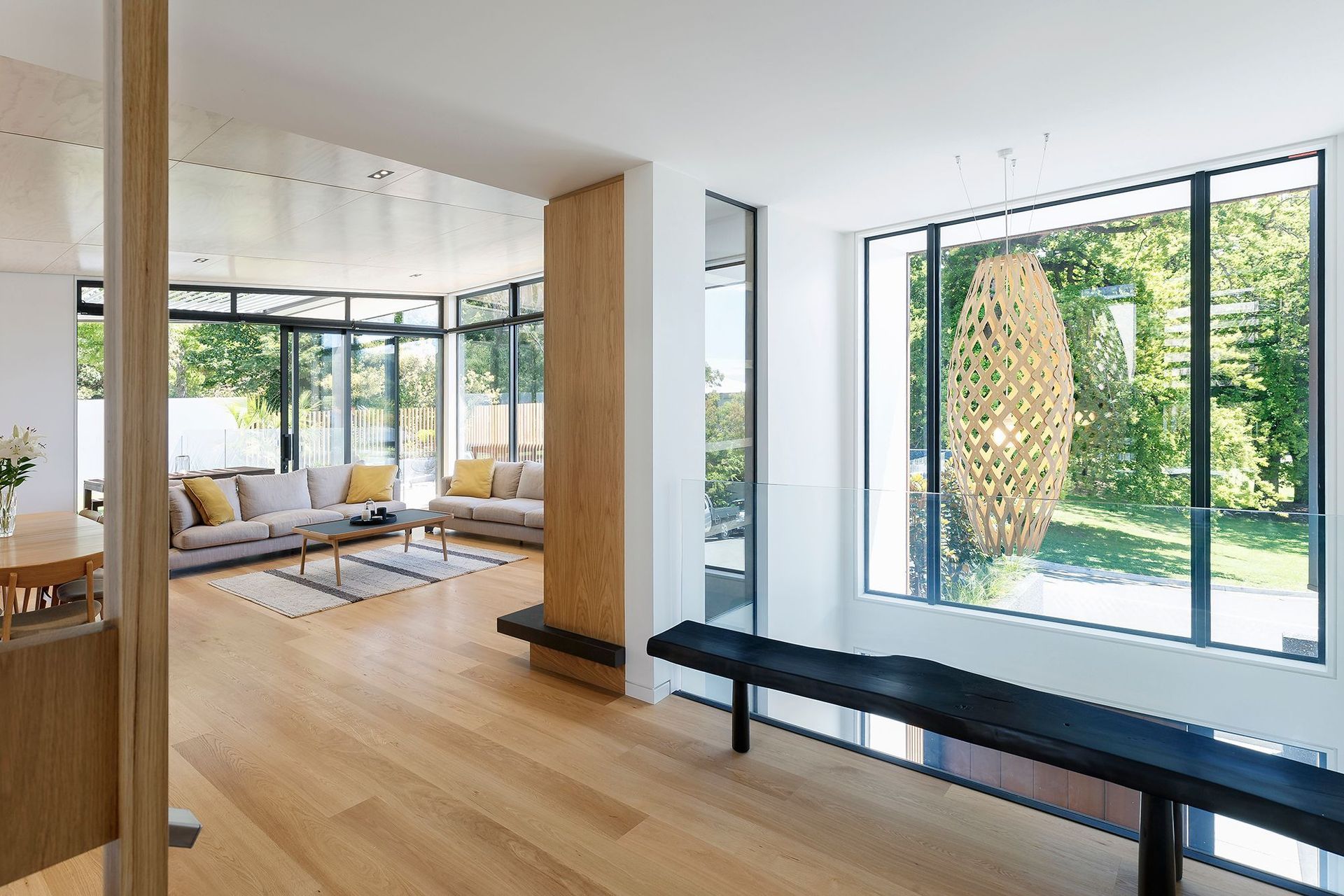 The bridge over the staircase opens up the landscape view with a glass balustrade and a large picture window.