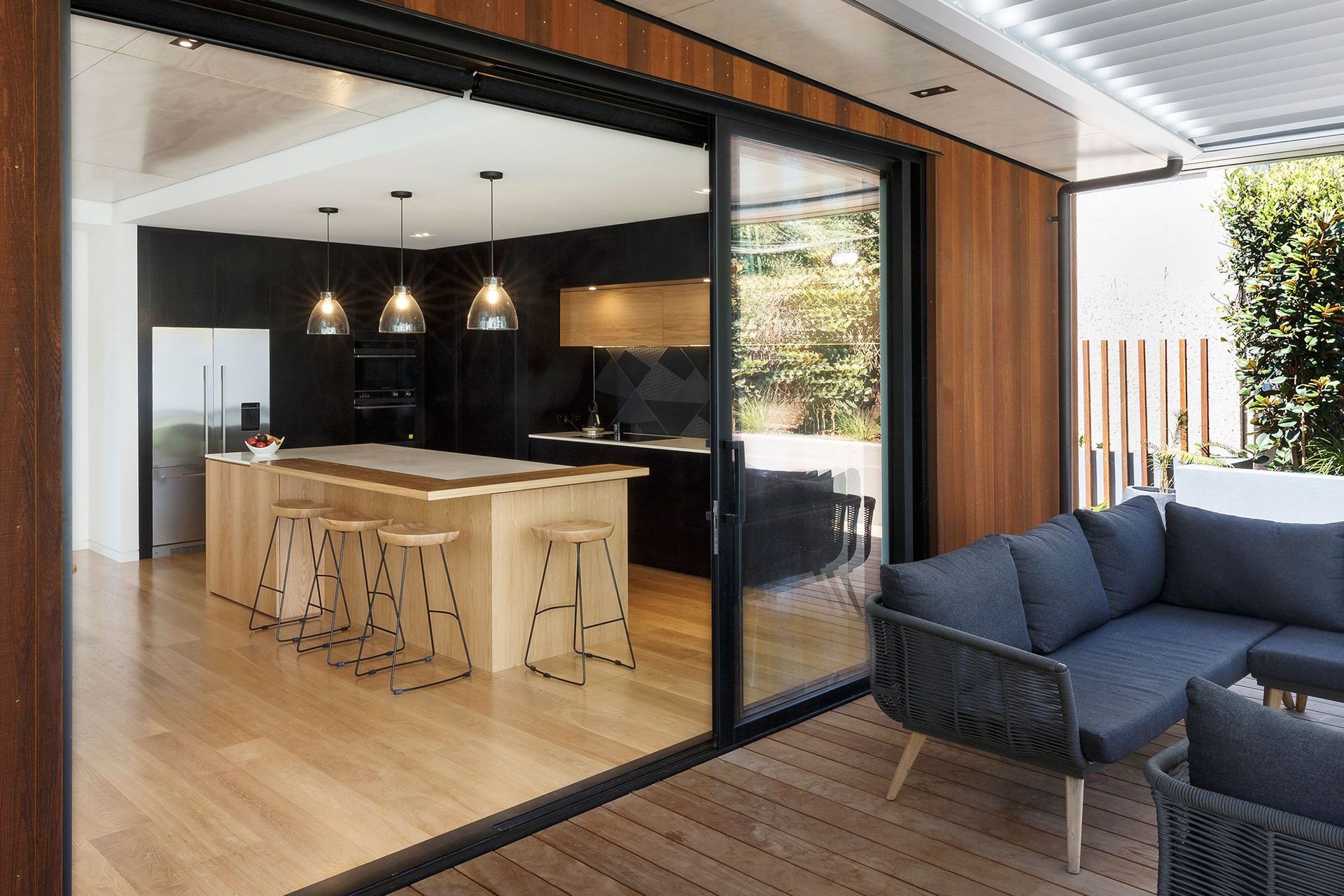 The kitchen viewed from the outdoor lounge area.