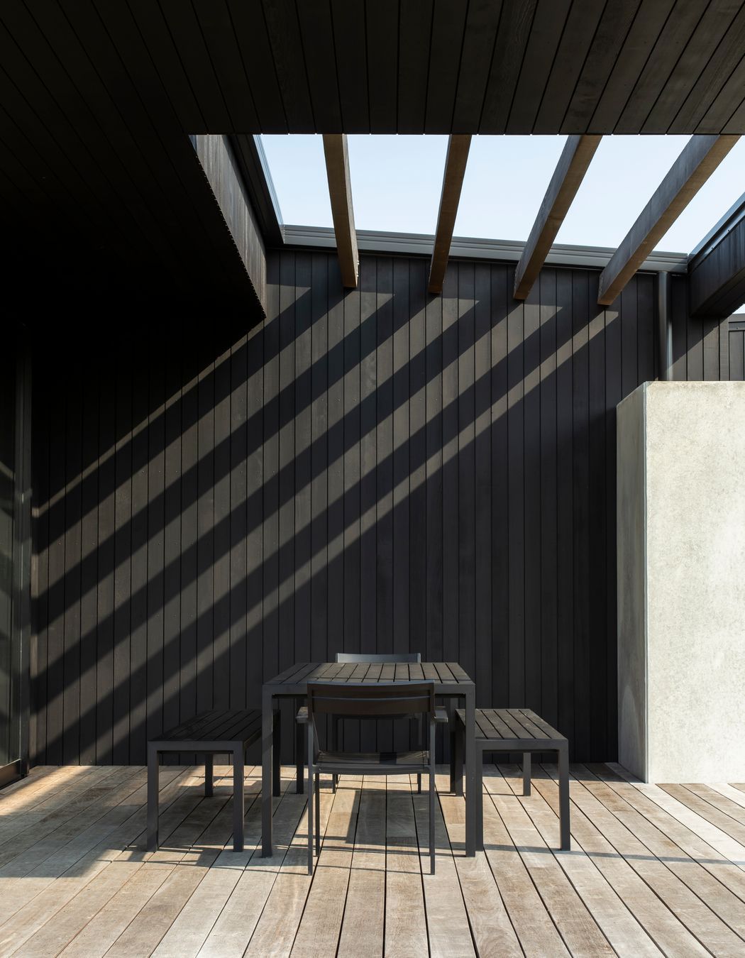 Off to the side of the house, this partially covered outdoor area admits morning sun into the house.