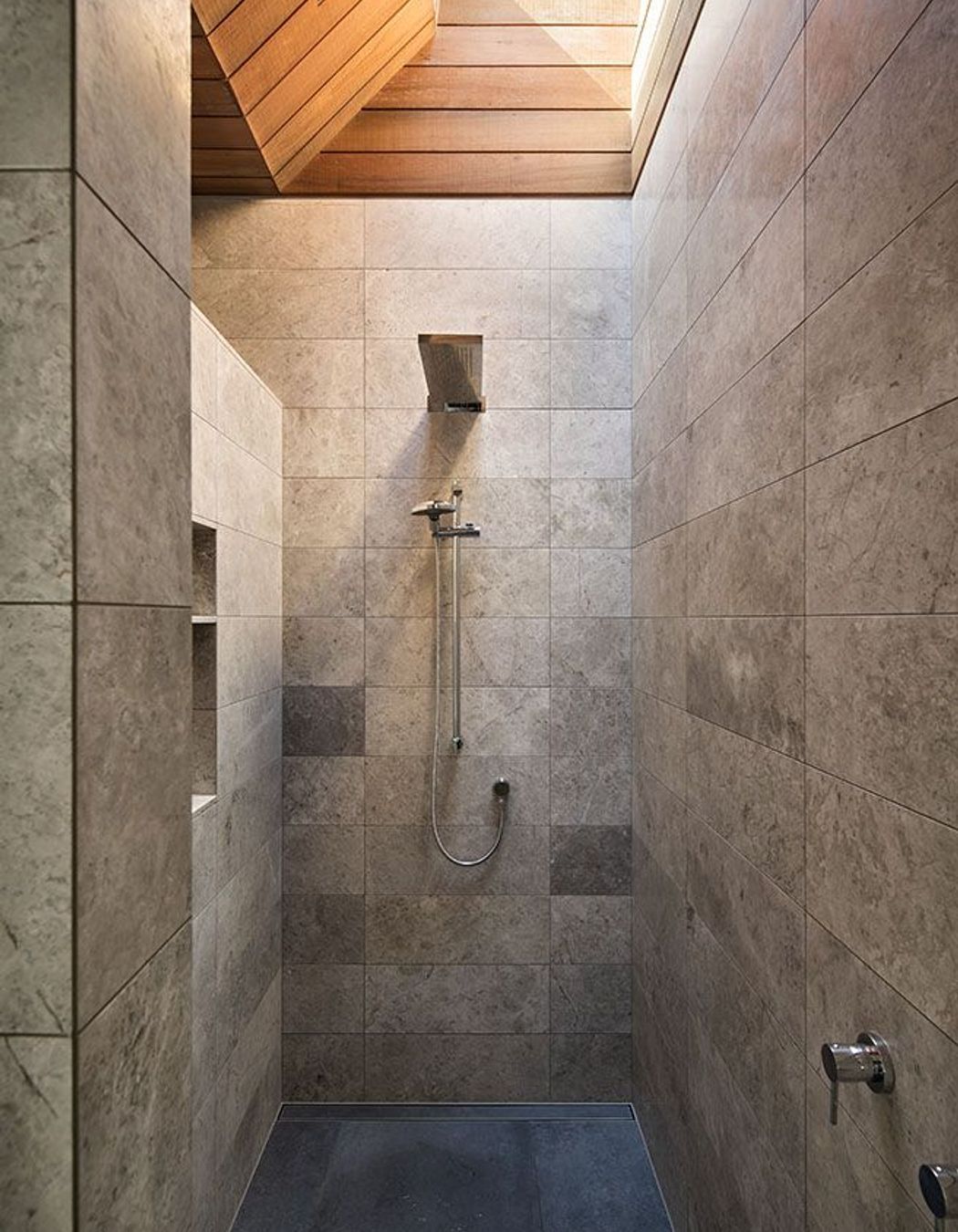 This shower features a skylight to draw in light from above.