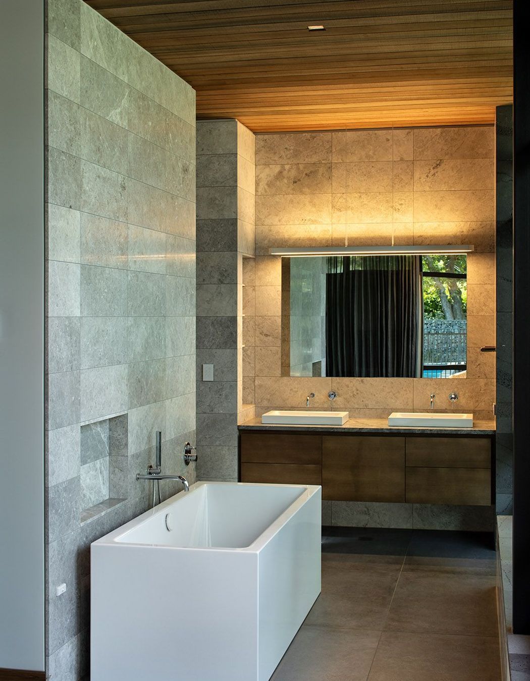 The bathrooms are lined in stone and timber to complement the rest of the house.