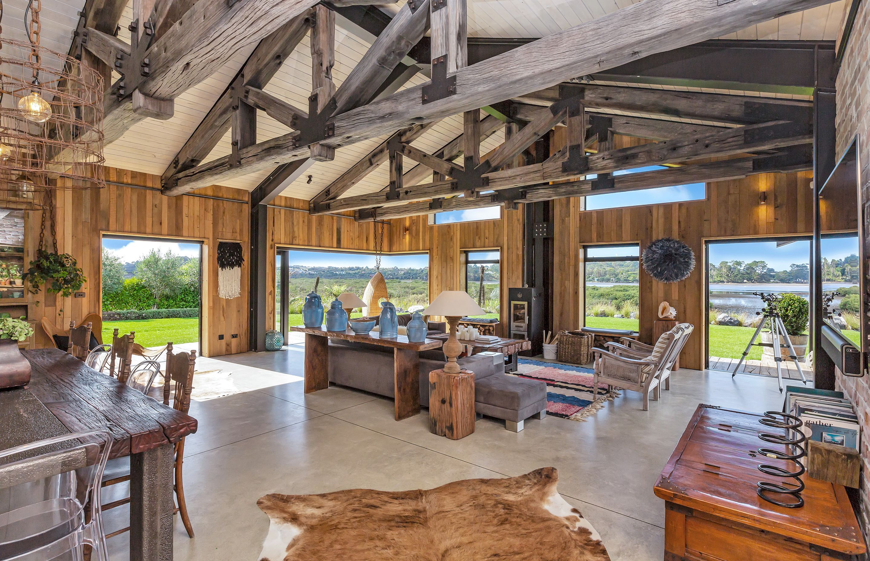 Windows and doors surrounding the living area provide framed views of the countryside and the waterfront.
