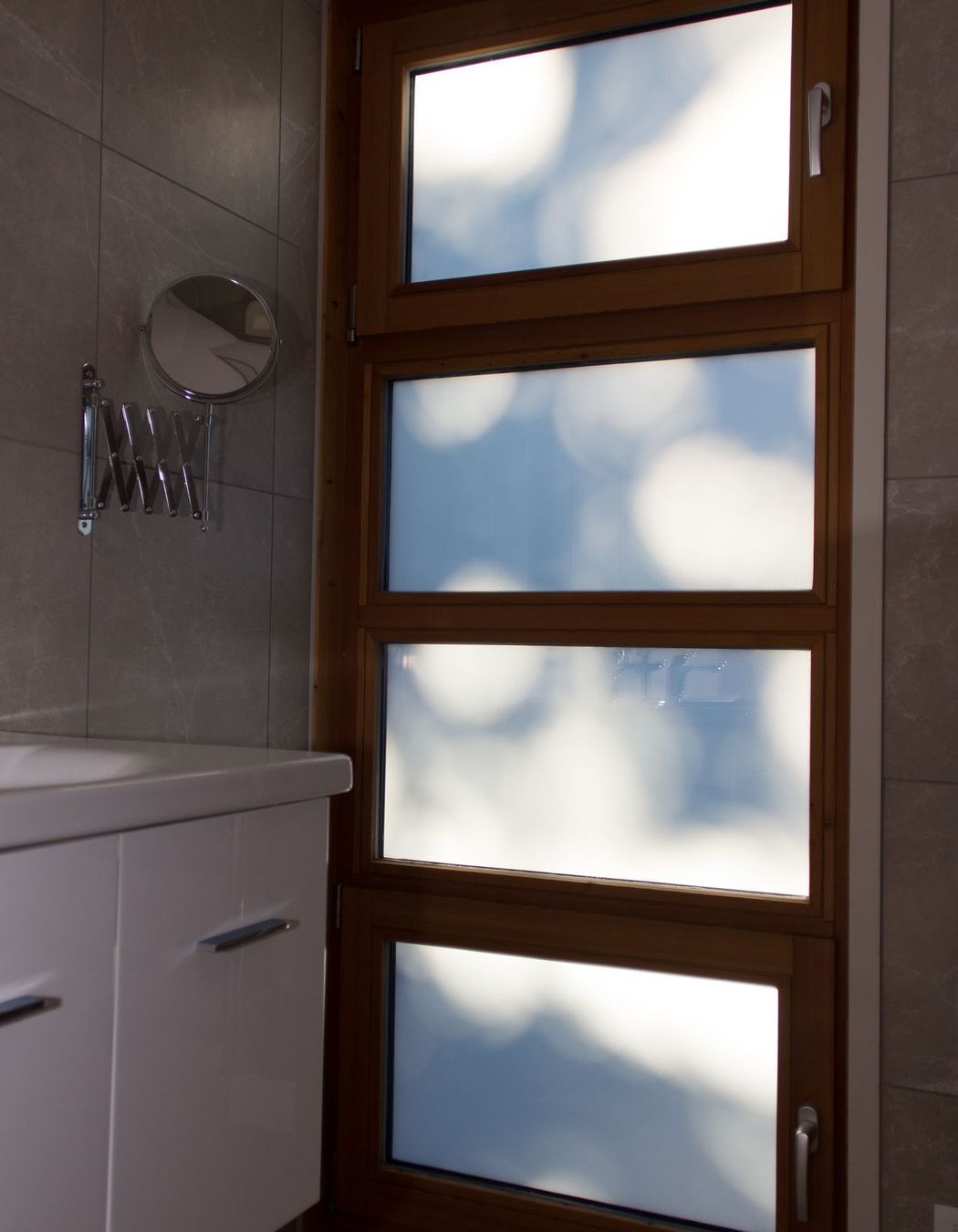 The morning sun casts interesting shadows on this bathroom window.