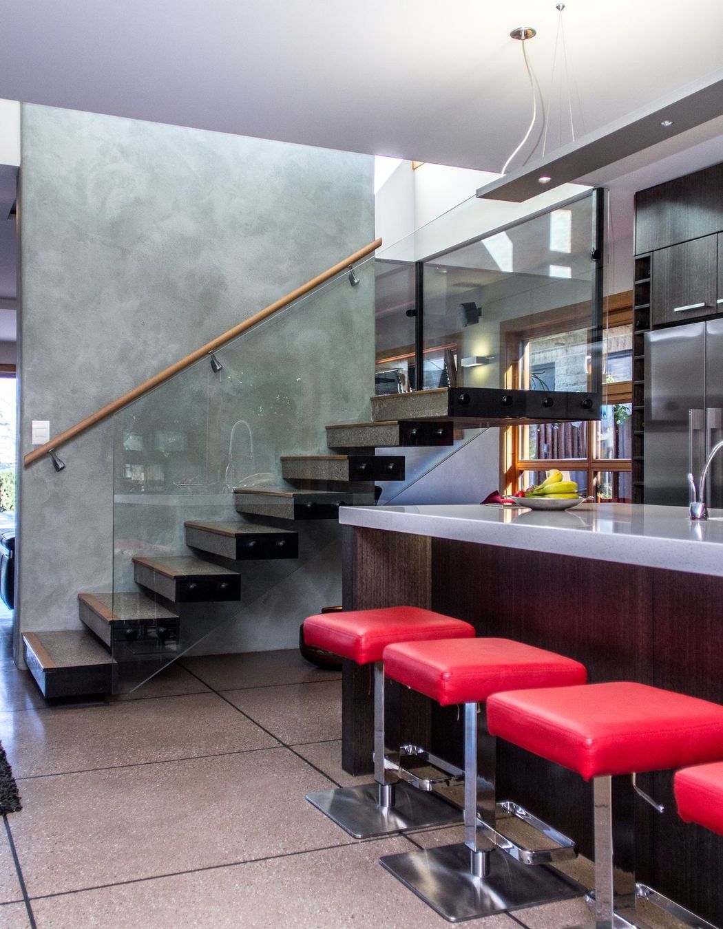 The concrete stairs 'float', hanging from the supporting wall.