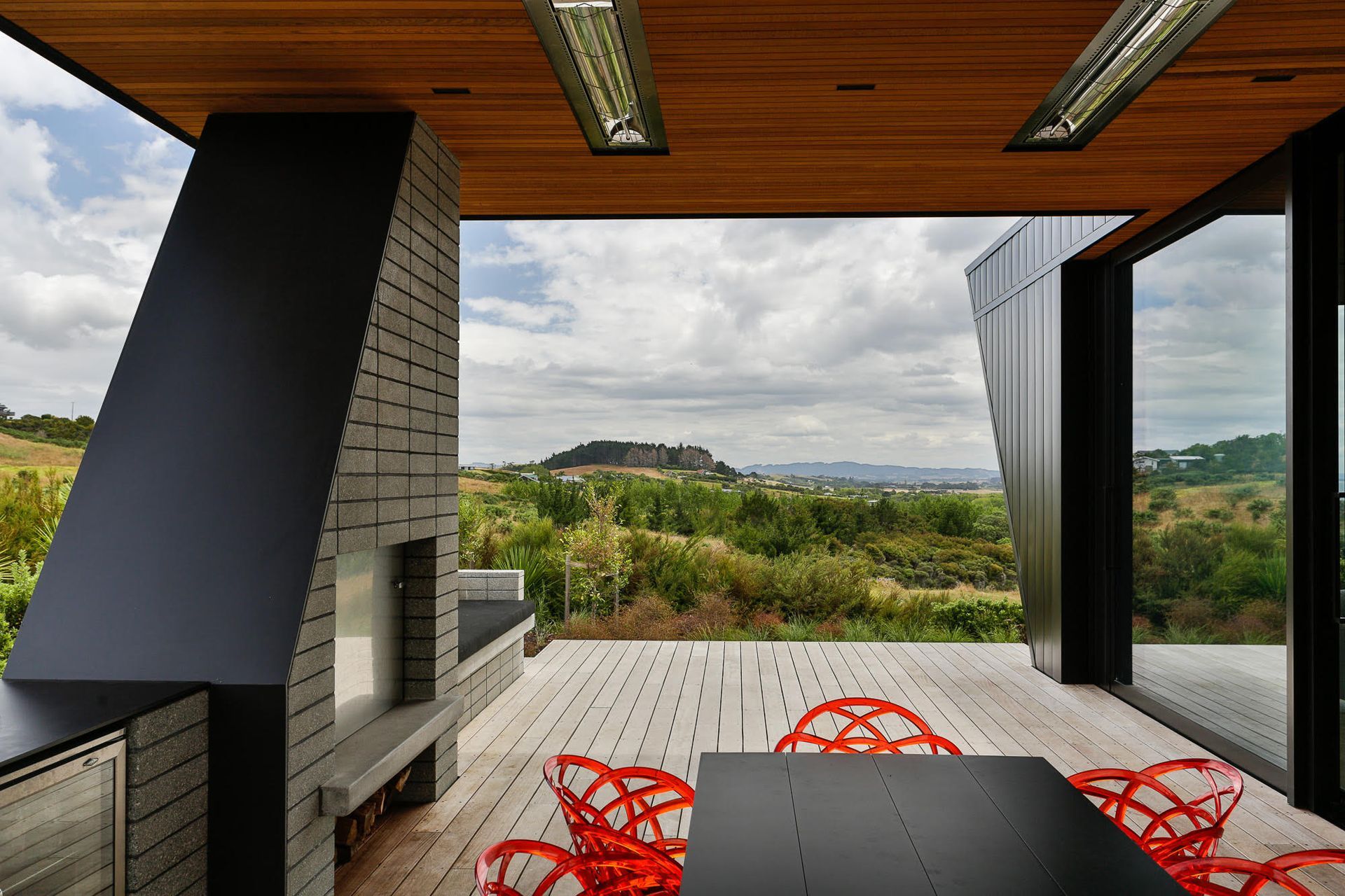 The southeast facing sheltered outdoor space is heralded by an outdoor fire and kitchen. 